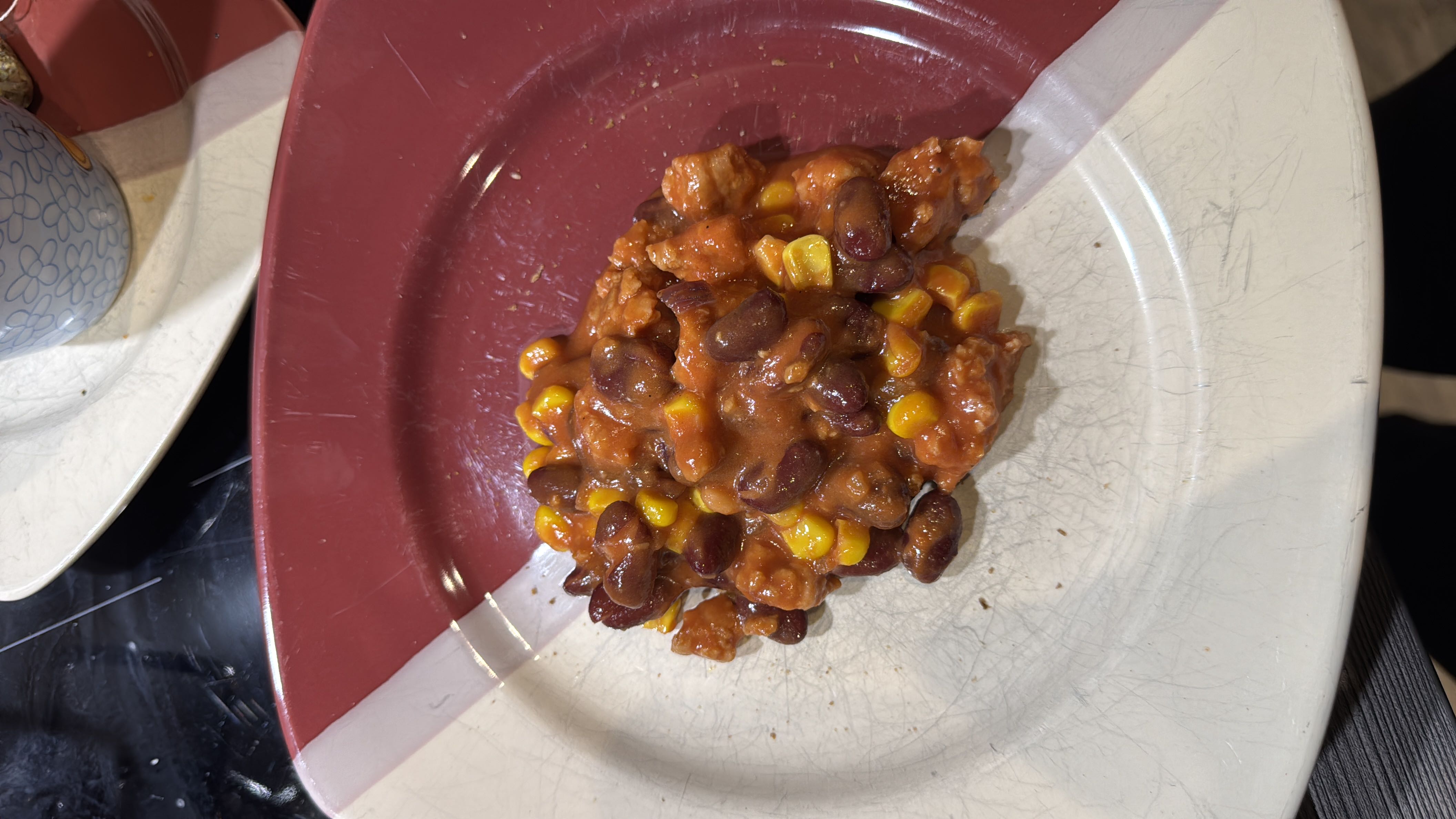 A dish consisting of kidney beans, corn, tomato sauce, and vegan minced meat, providing a balanced mix of protein, carbs, and fats.