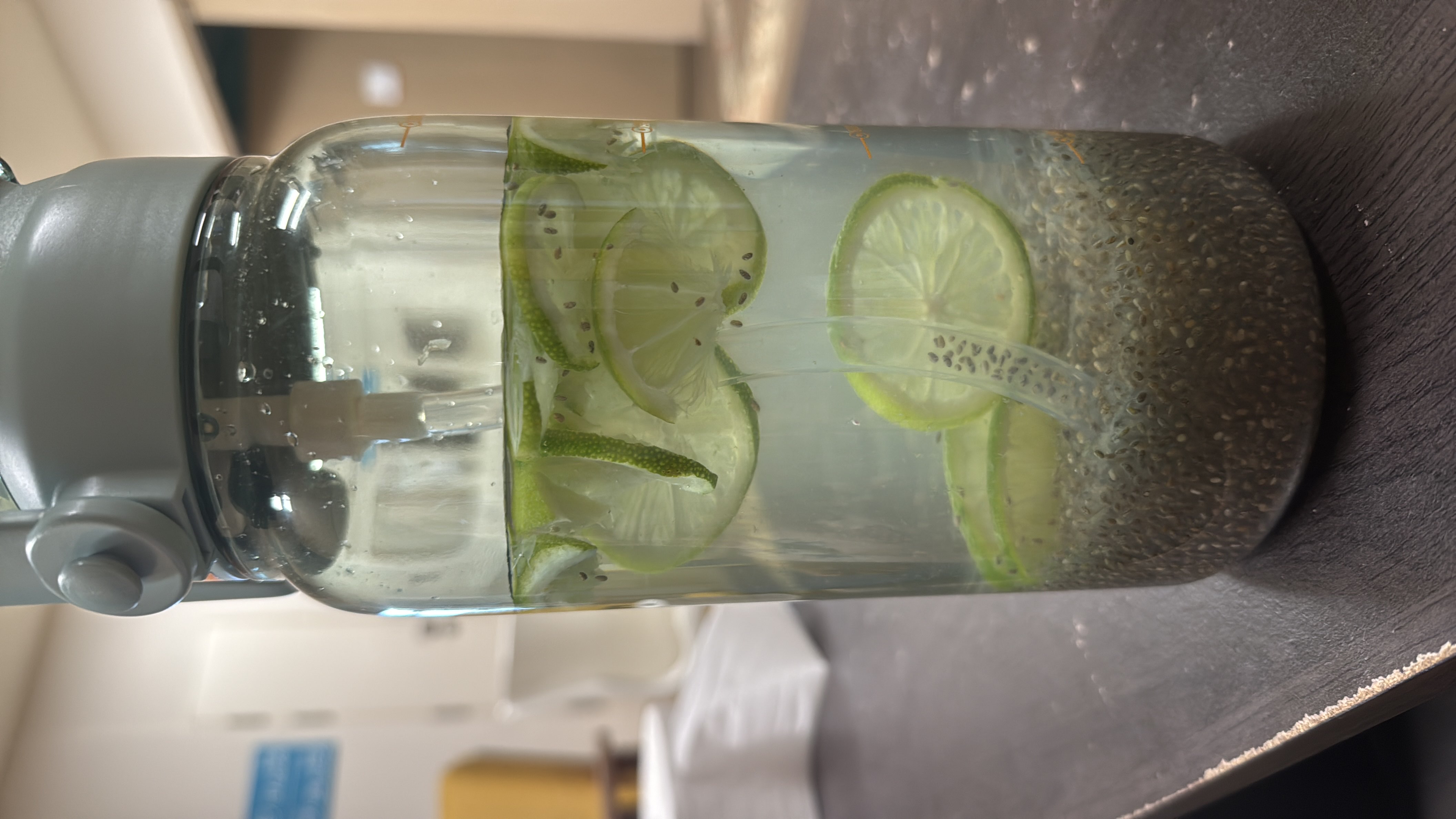 A refreshing infused water with lime slices and chia seeds, providing hydration and a boost of nutrients.