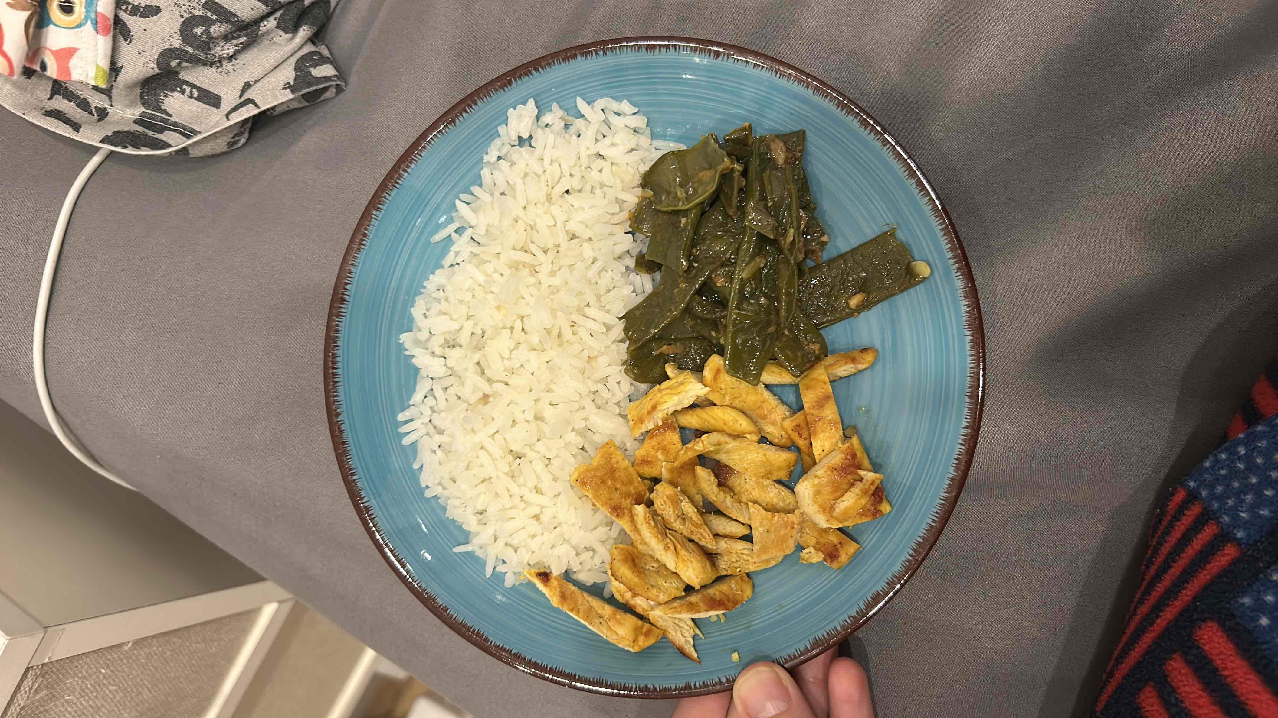 A balanced meal consisting of grilled chicken, white rice, and cooked green beans, providing a good mix of protein, carbohydrates, and fiber.