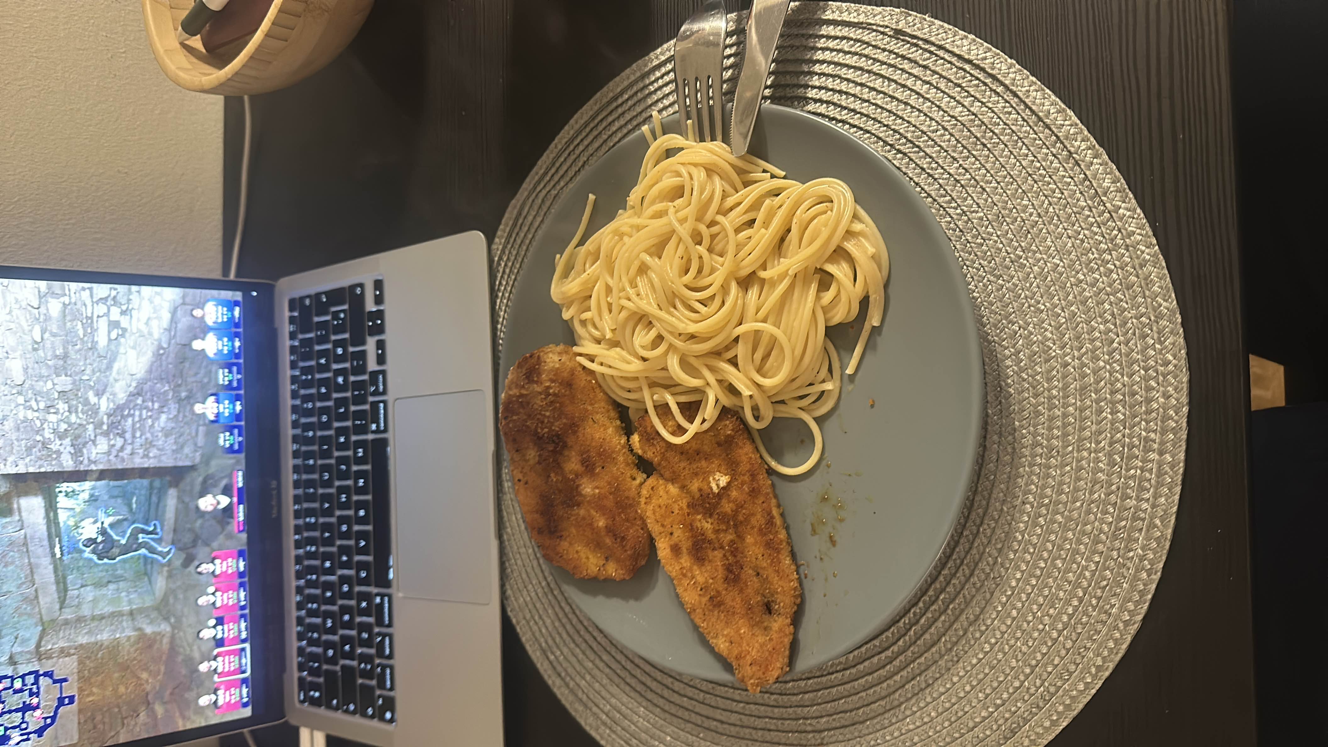 A plate of breaded chicken and spaghetti, providing a balanced mix of protein, carbs, and fats.