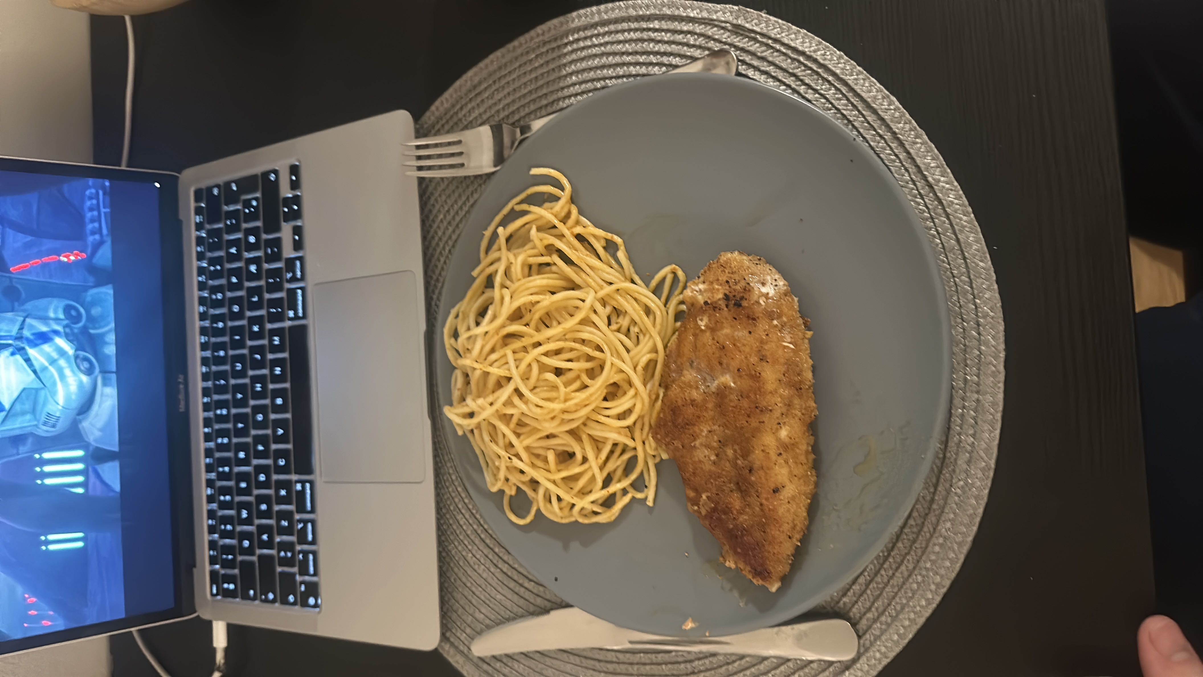 A plate containing a serving of breaded chicken breast and spaghetti, providing a balanced meal with protein, carbohydrates, and fats.