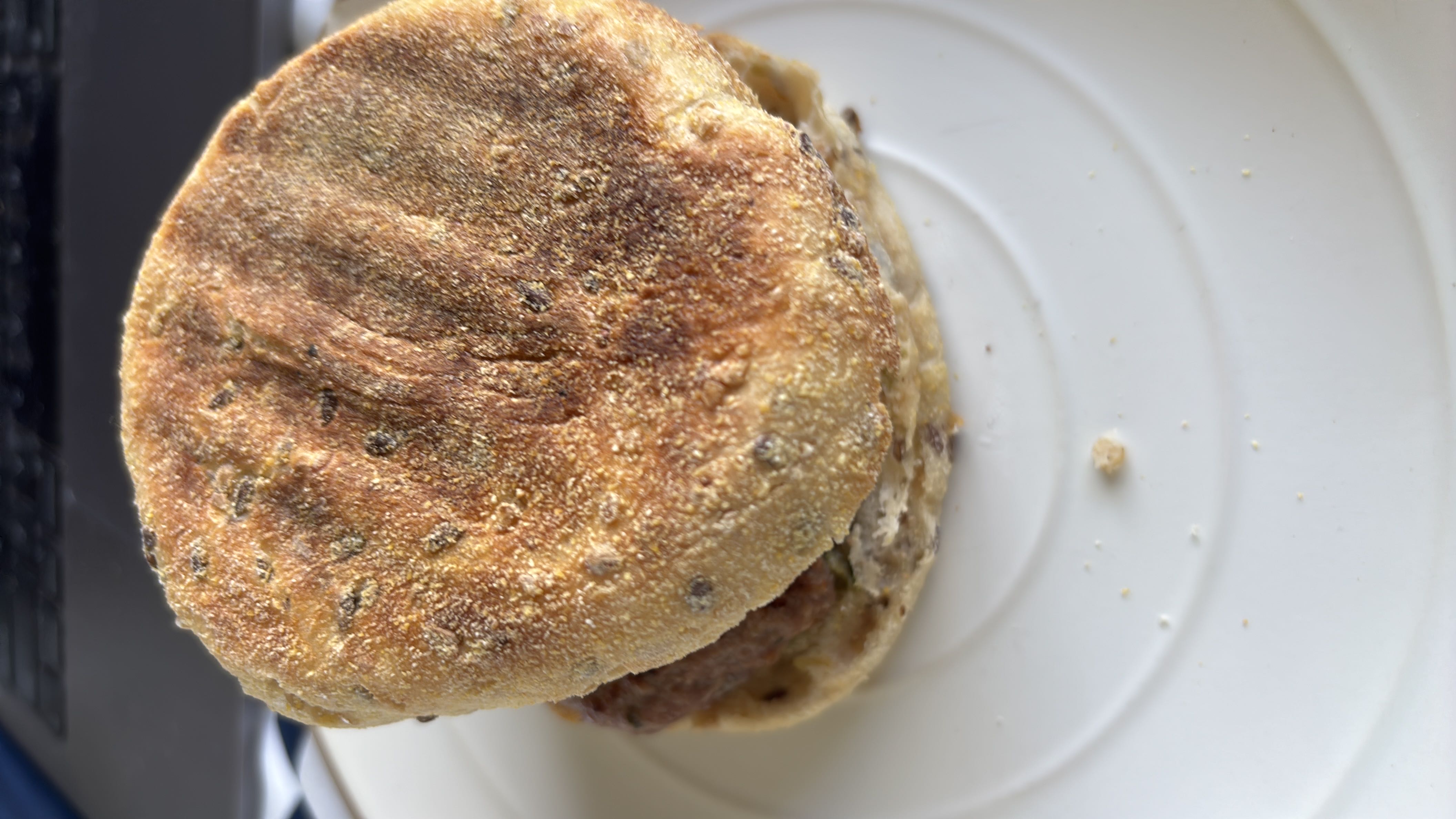 A sandwich made with a whole grain bun, beef patty, and cheese, providing a balanced mix of protein, carbs, and fats.