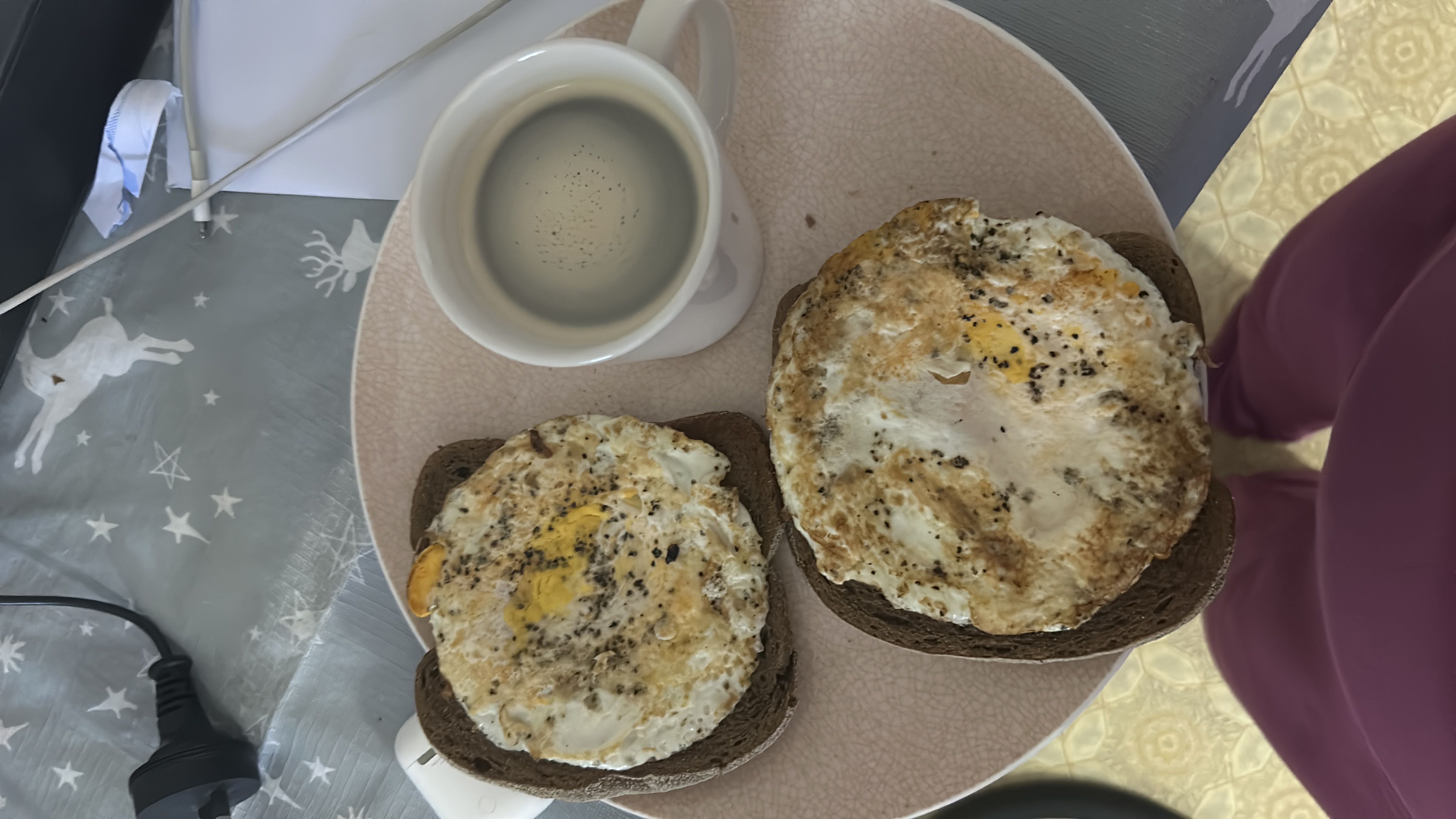 A meal consisting of two fried eggs on bread and a cup of milk, providing a balanced mix of protein, carbs, and fats.