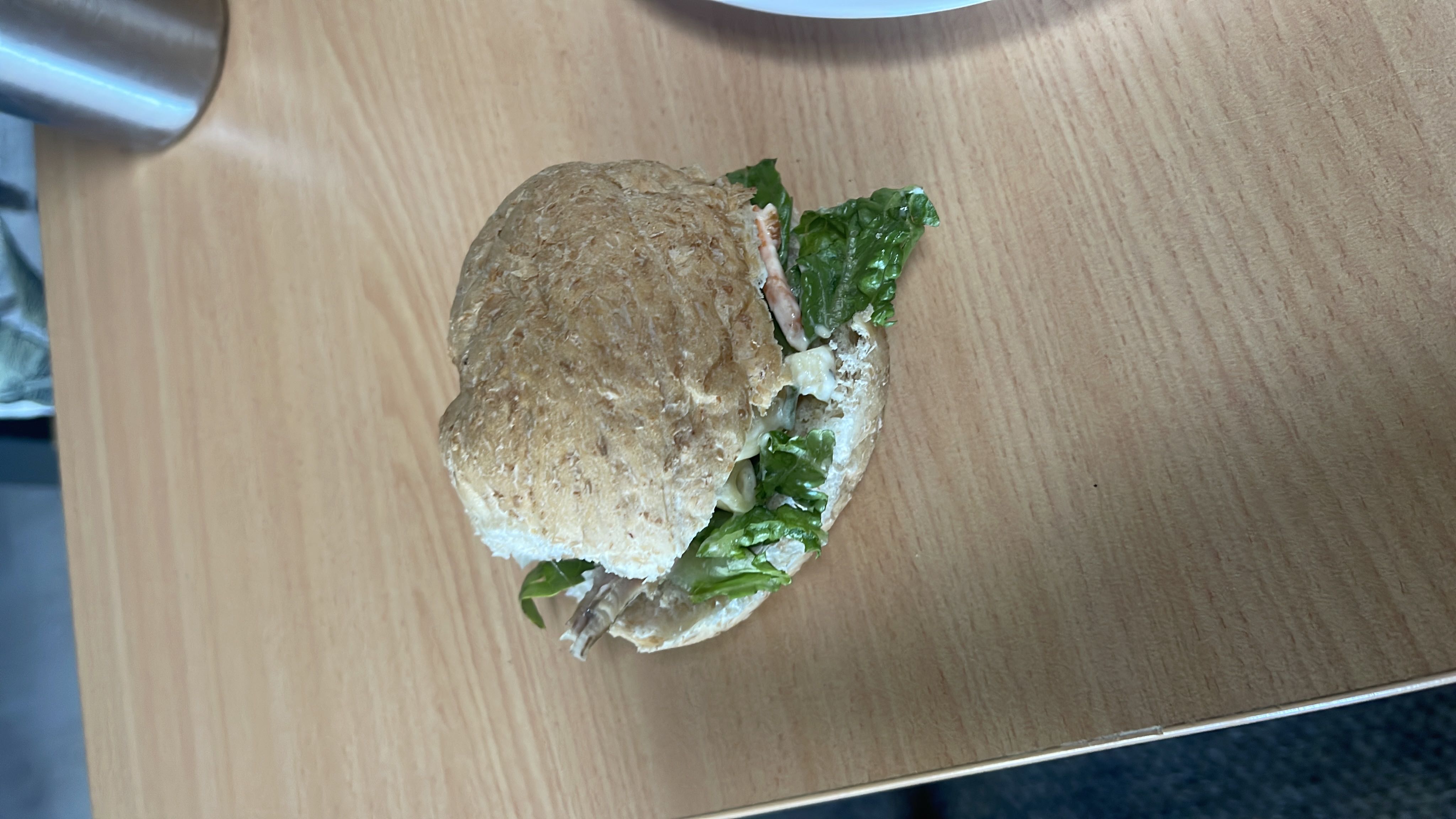 A healthy sandwich made with whole grain bread, lettuce, chicken, and mayonnaise.