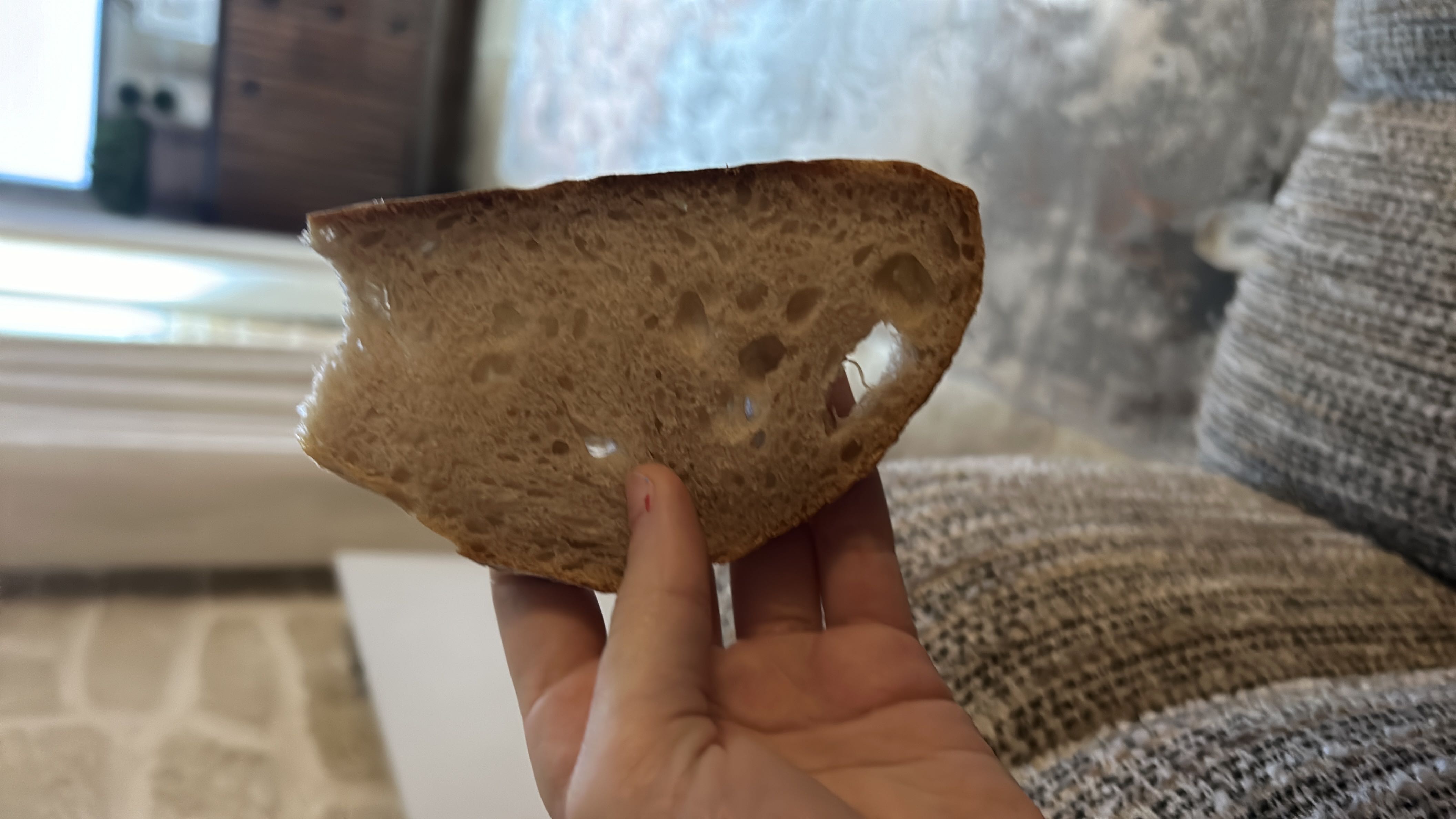 A single slice of bread, likely whole grain or sourdough, with moderate nutritional content.