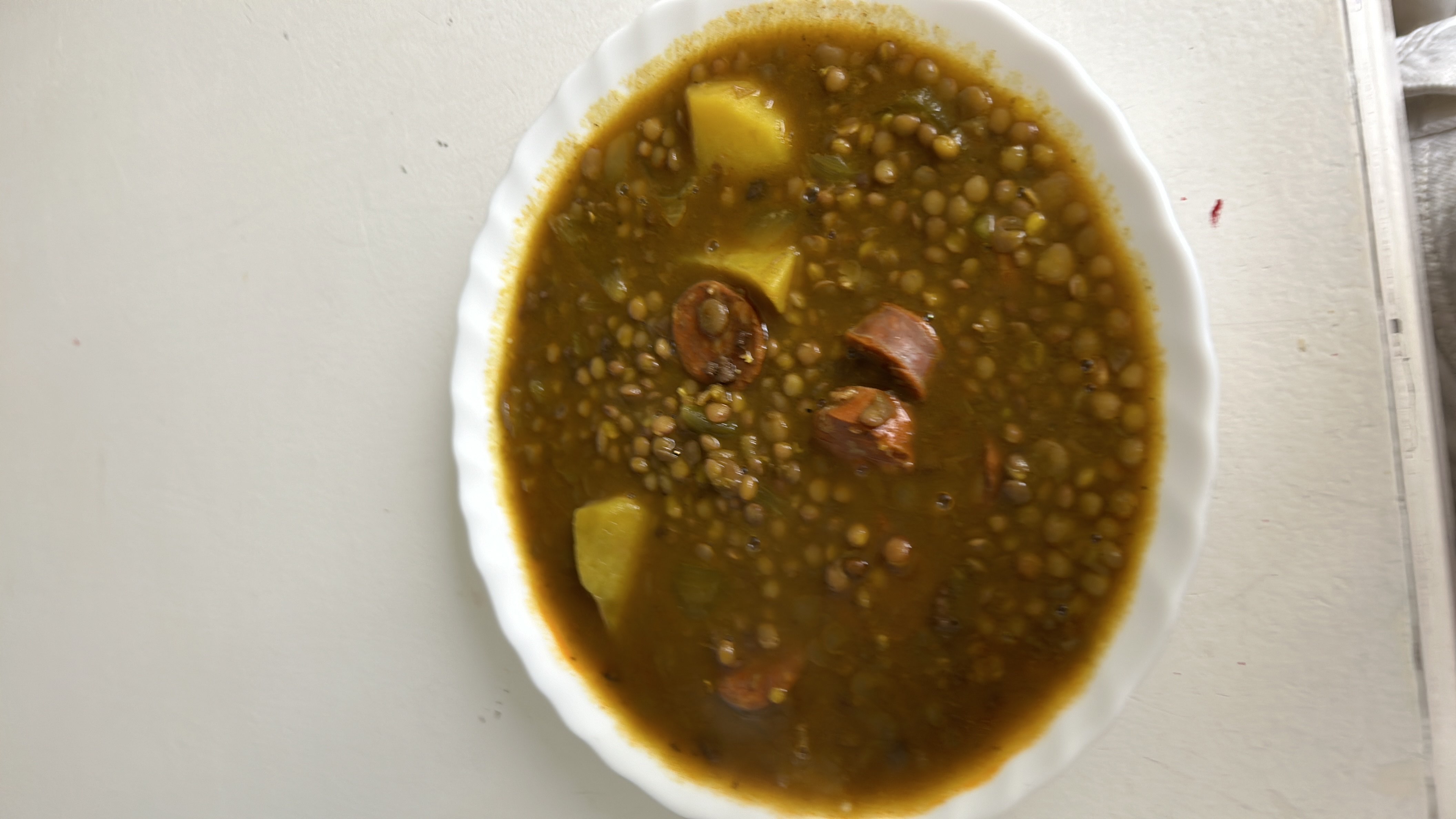 A hearty lentil stew with potatoes and sausage, providing a balanced mix of protein, carbs, and fats.