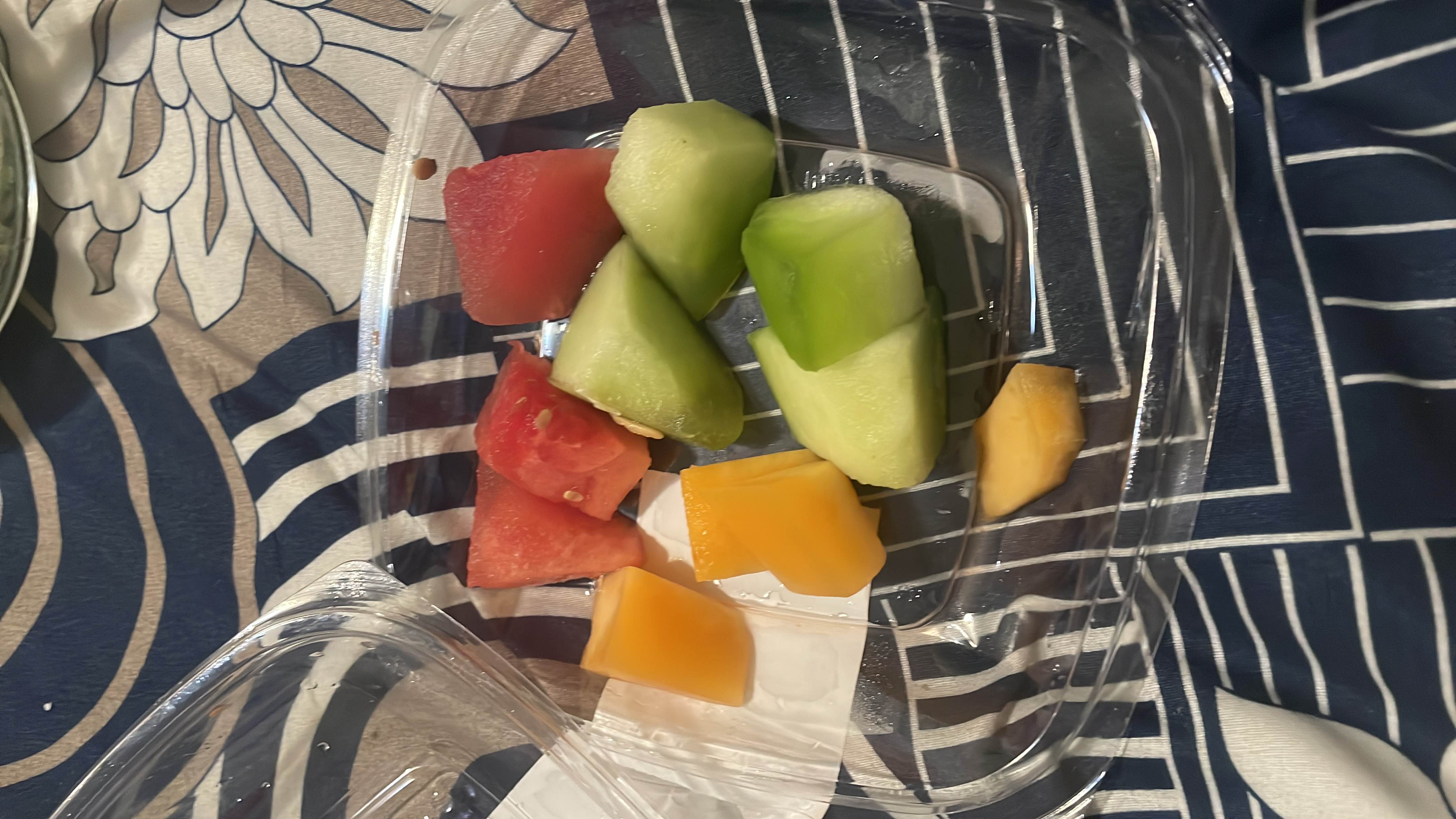 A fresh fruit mix containing watermelon, cantaloupe, and honeydew, providing a low-calorie, hydrating snack.