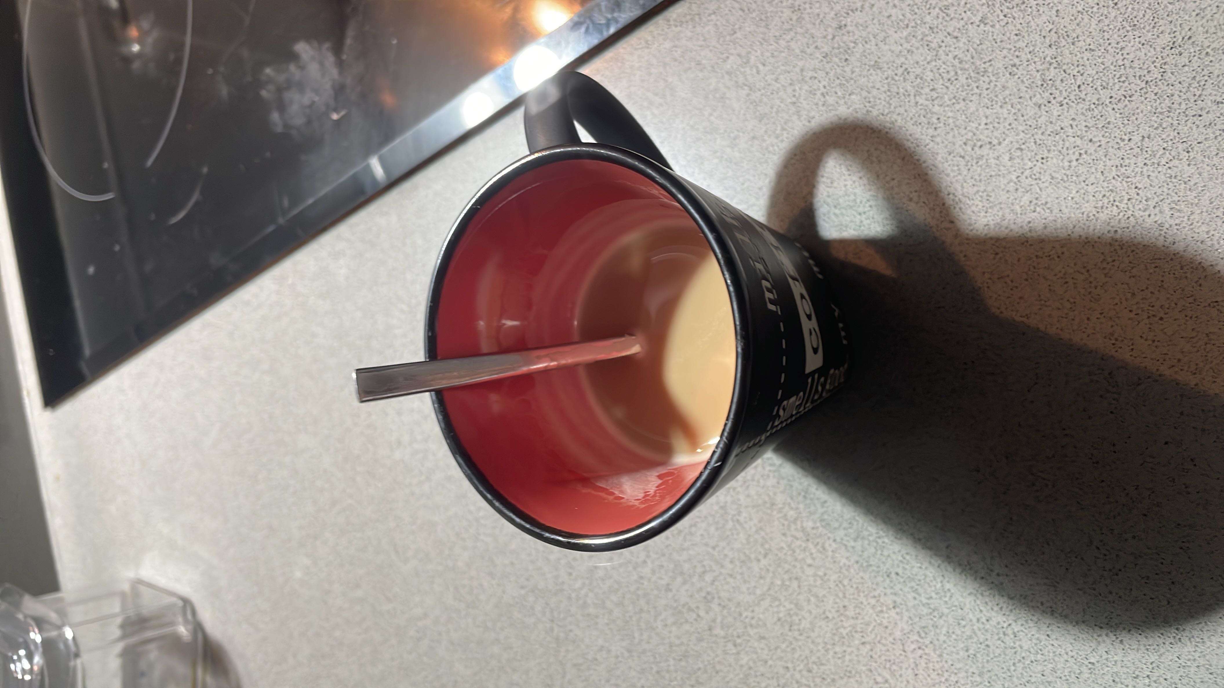 A cup of coffee with milk, providing a moderate amount of calories and nutrients.