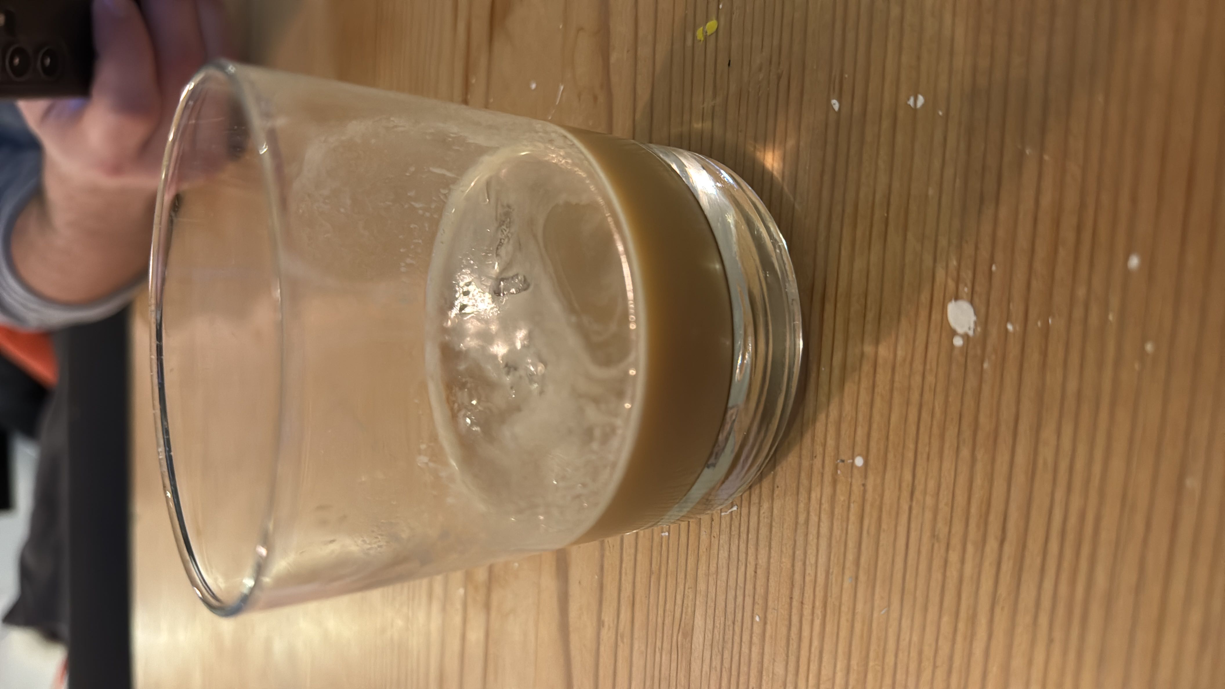 A refreshing iced espresso beverage with a bit of milk, served without sugar.