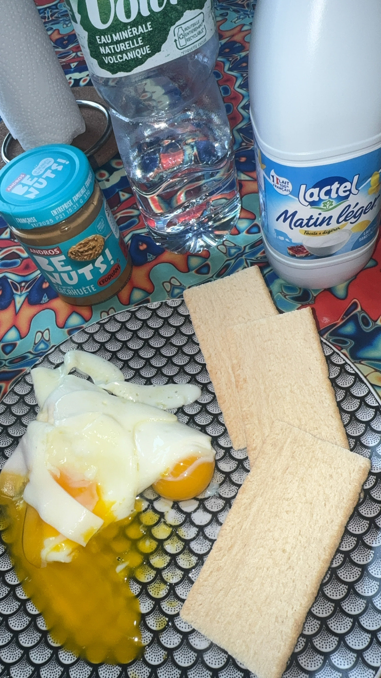 A balanced meal consisting of eggs, peanut butter, crispbread, and milk, providing a good mix of protein, carbs, and fats.