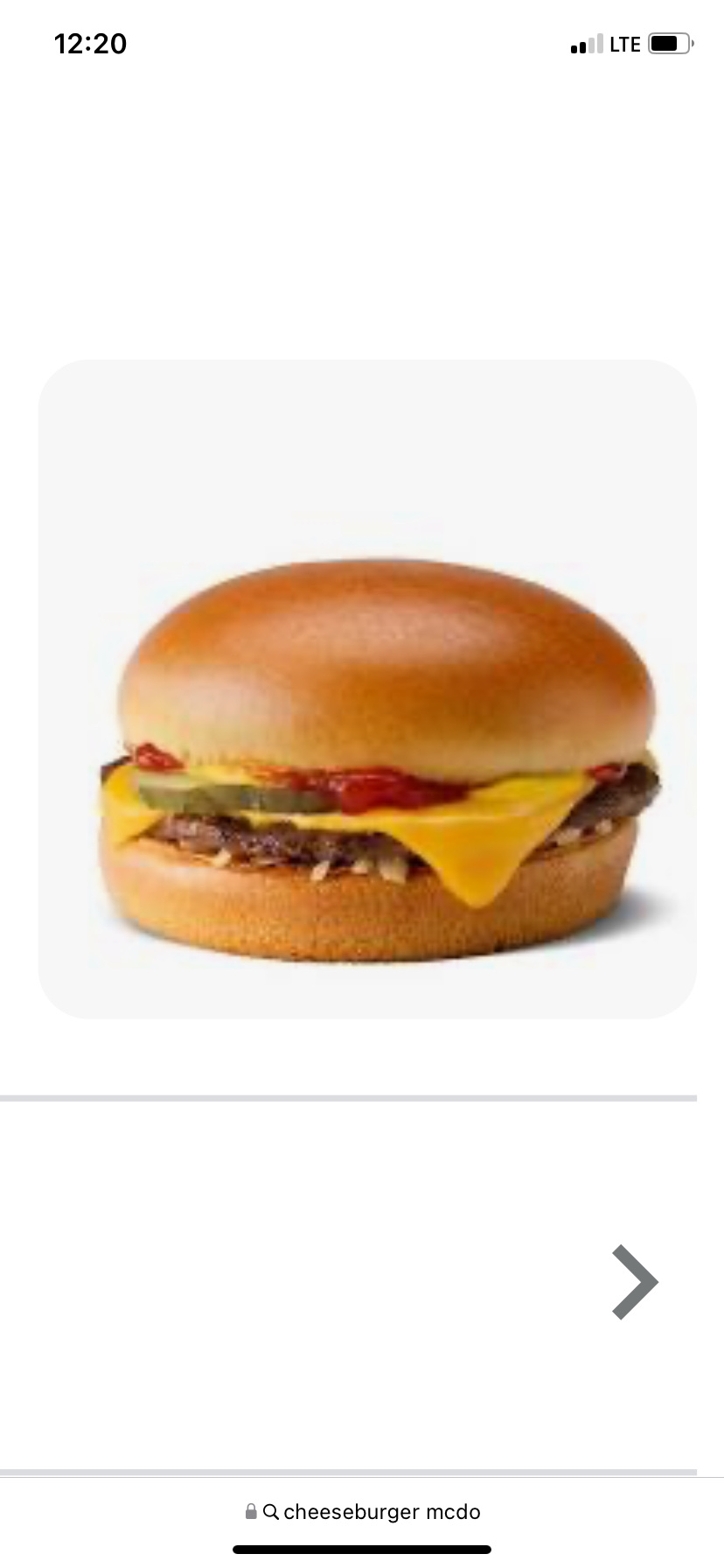 A cheeseburger consisting of a beef patty, cheese, and a bun, with condiments such as ketchup and pickles.