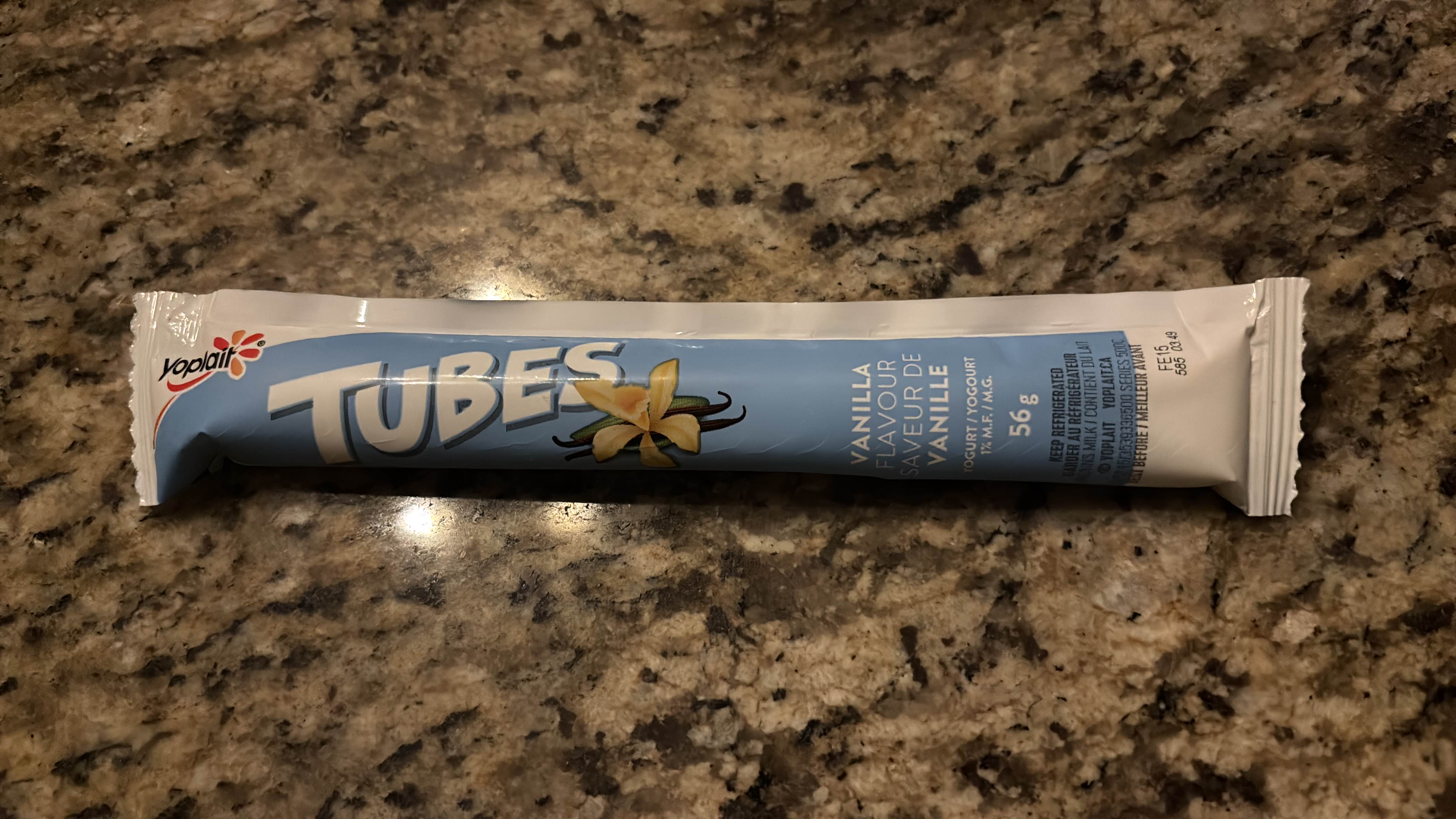 A 56g vanilla-flavored yogurt tube with 1% milk fat, providing a light and convenient snack option.