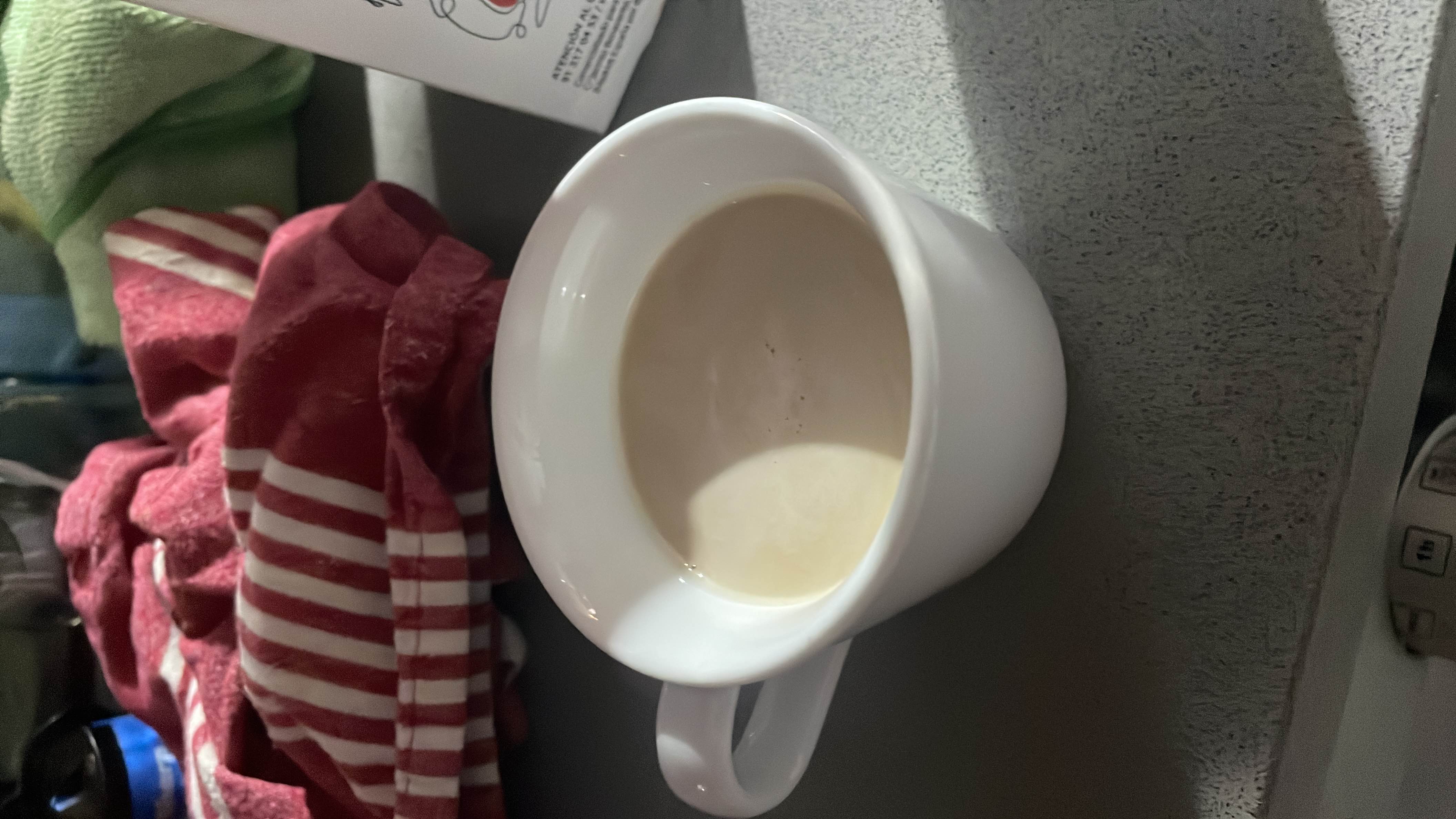 A cup of unsweetened milk-based beverage with moderate calories and a balanced nutritional profile.