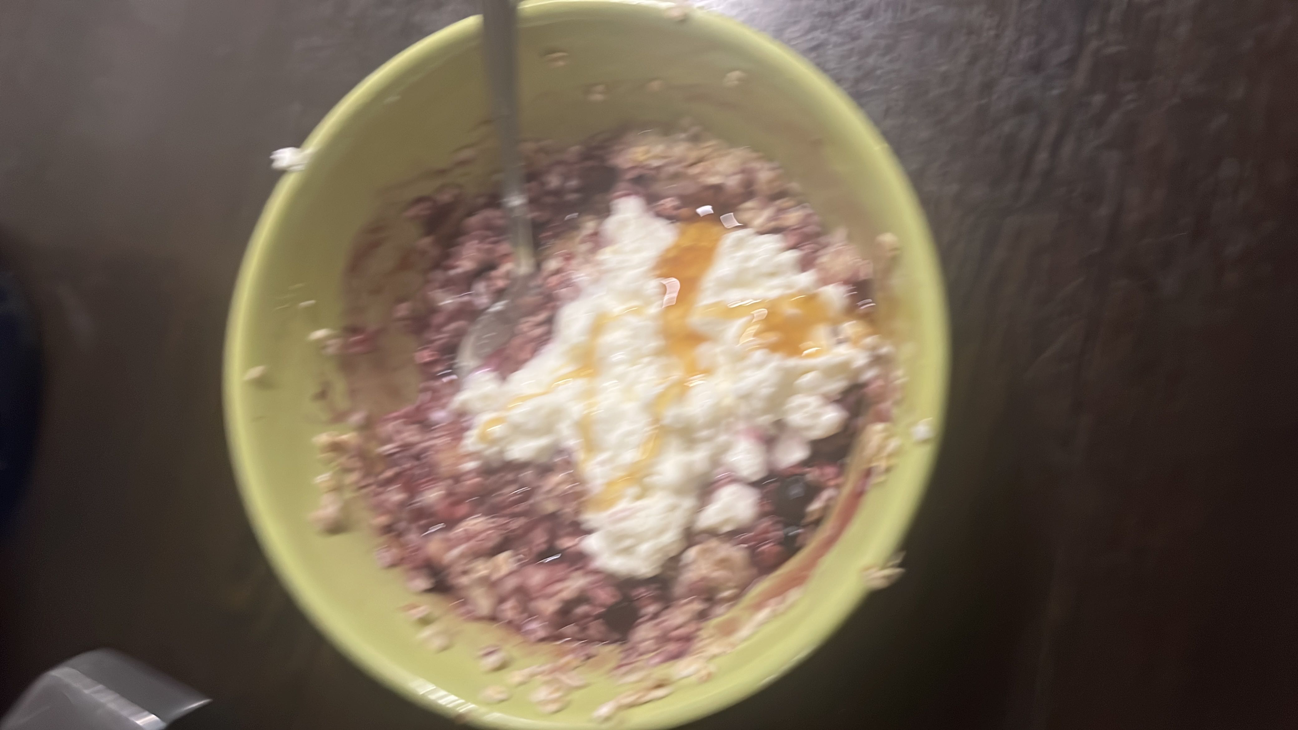 A bowl of oatmeal topped with berries, cottage cheese, and honey, providing a balanced mix of protein, carbs, and fats.