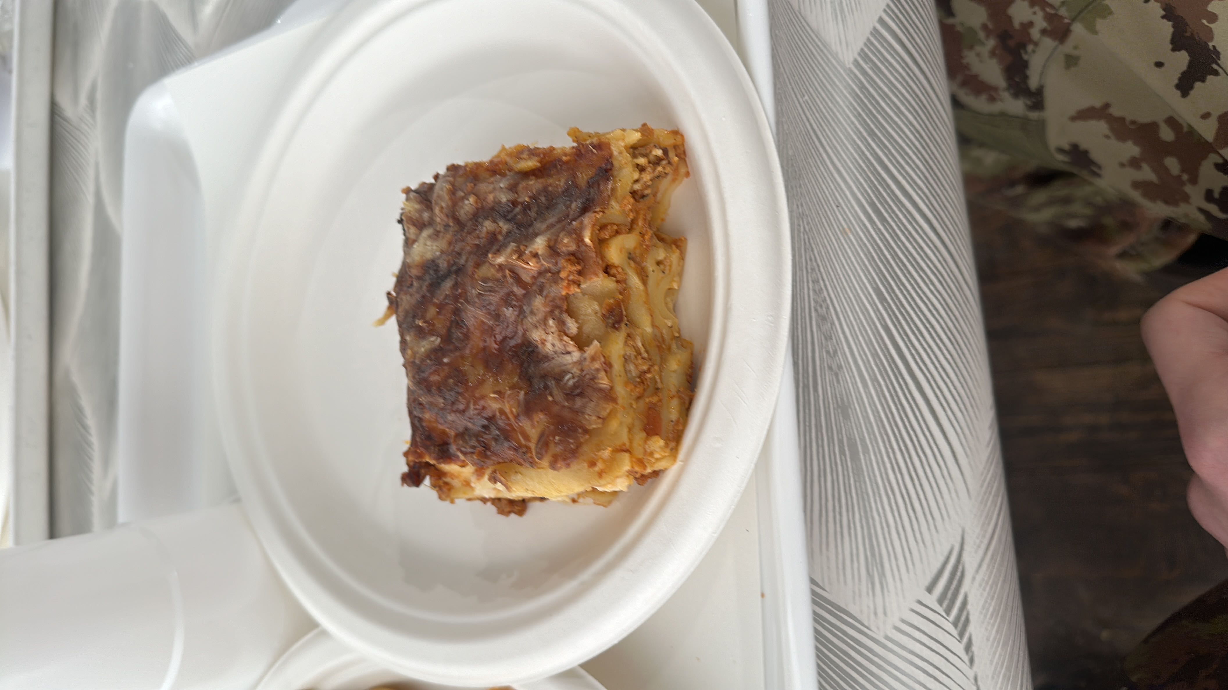A serving of lasagna with layers of pasta, meat sauce, and cheese, providing a balanced mix of protein, carbs, and fats.