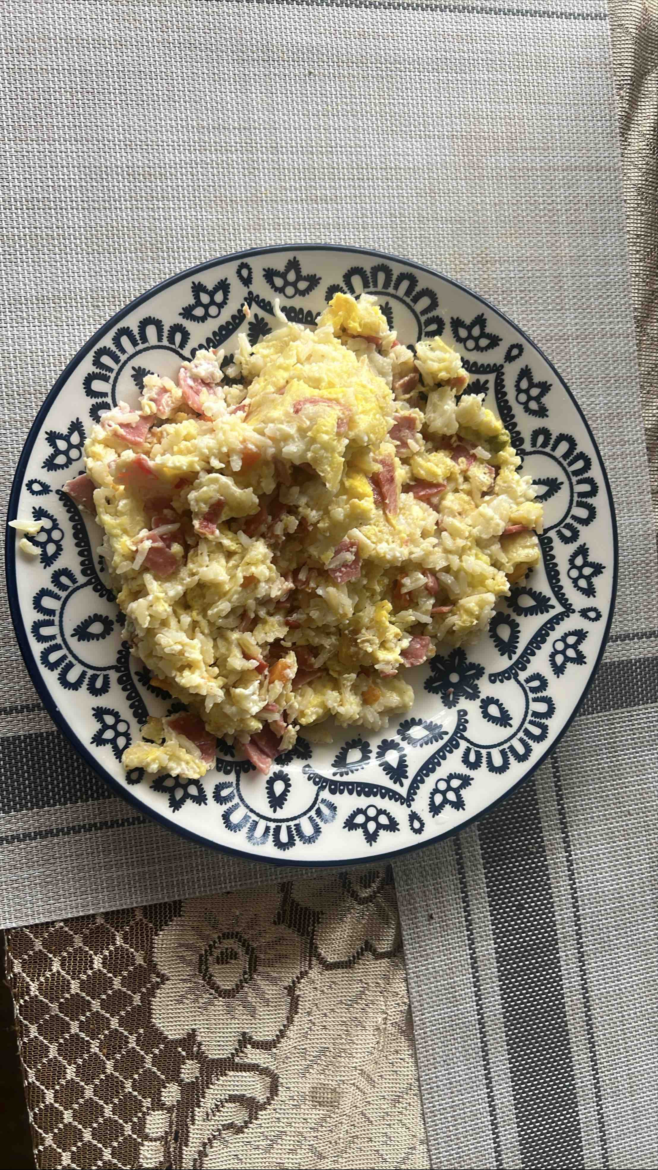 A dish consisting of scrambled eggs, rice, and ham, providing a balanced mix of protein, carbs, and fats.