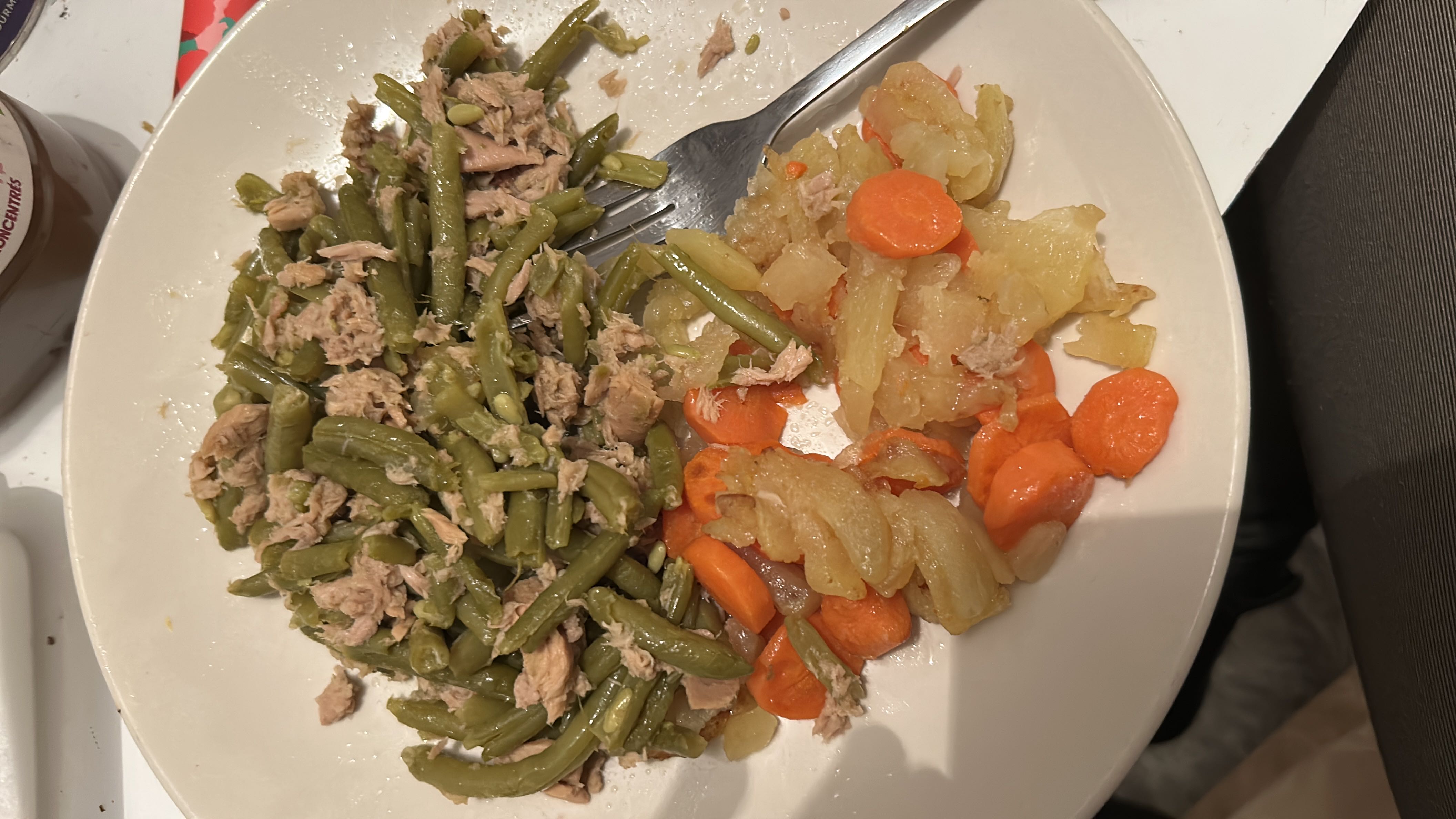 A balanced meal consisting of green beans, tuna, carrots, and potatoes, providing a good mix of protein, carbs, and fats.