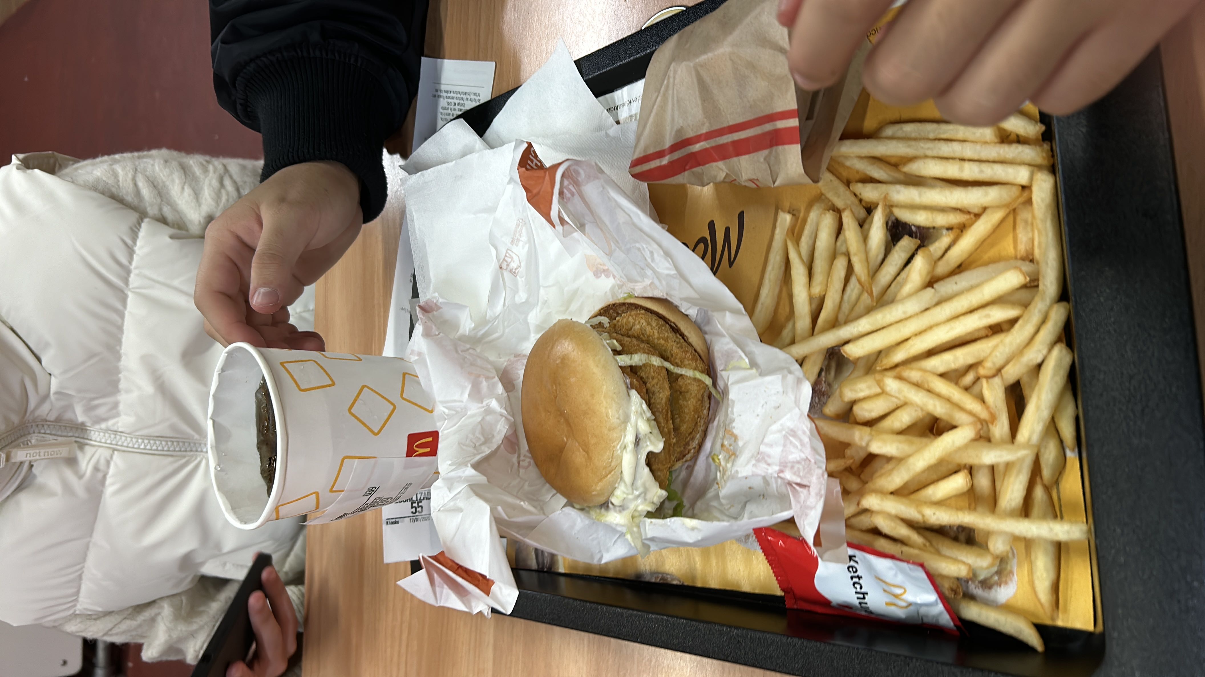 A meal consisting of a burger, fries, and a soft drink, providing a high-calorie fast food option with moderate protein and high carbohydrate content.