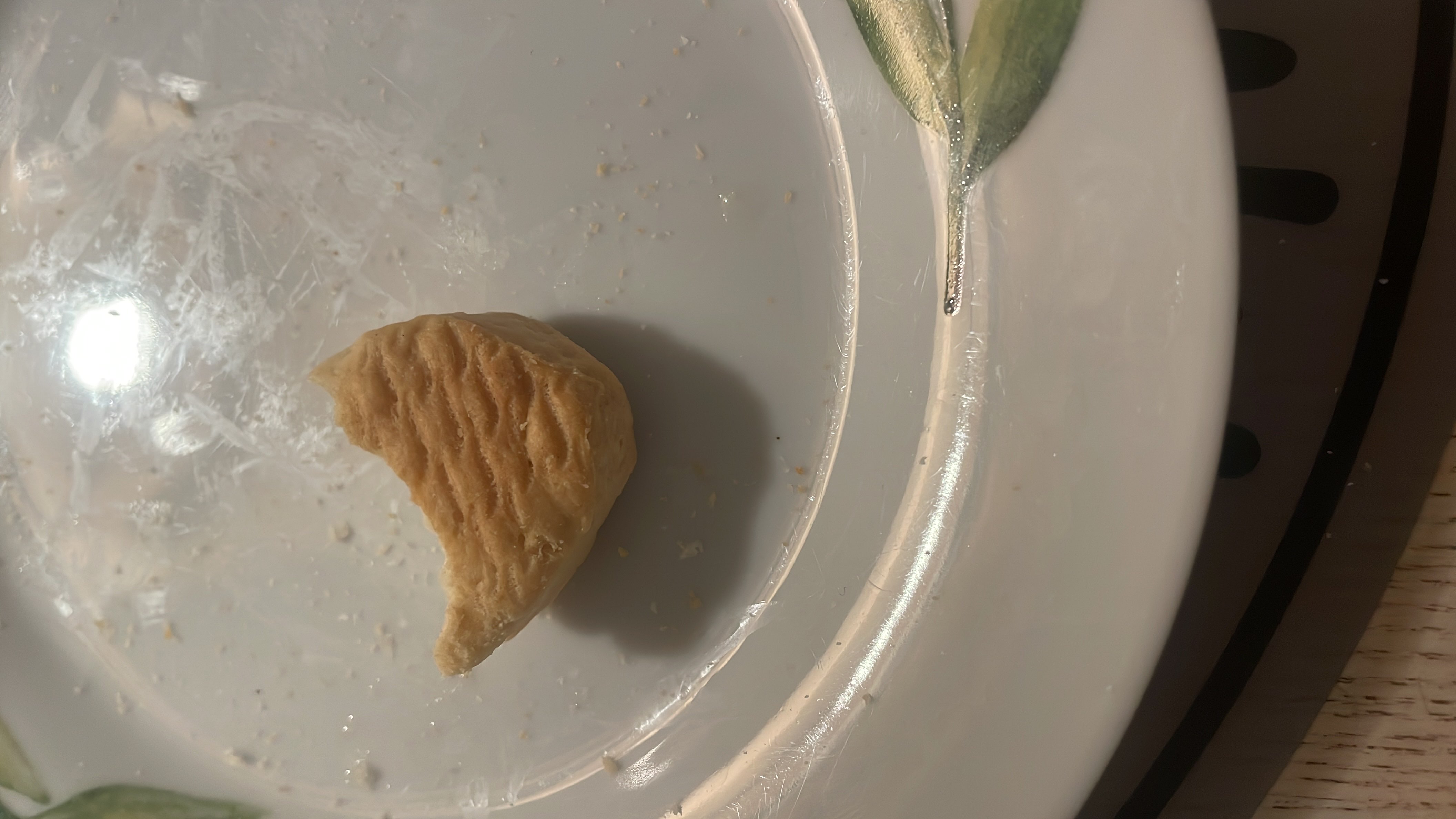A small piece of pastry with a flaky texture, likely high in carbohydrates and moderate in fats.