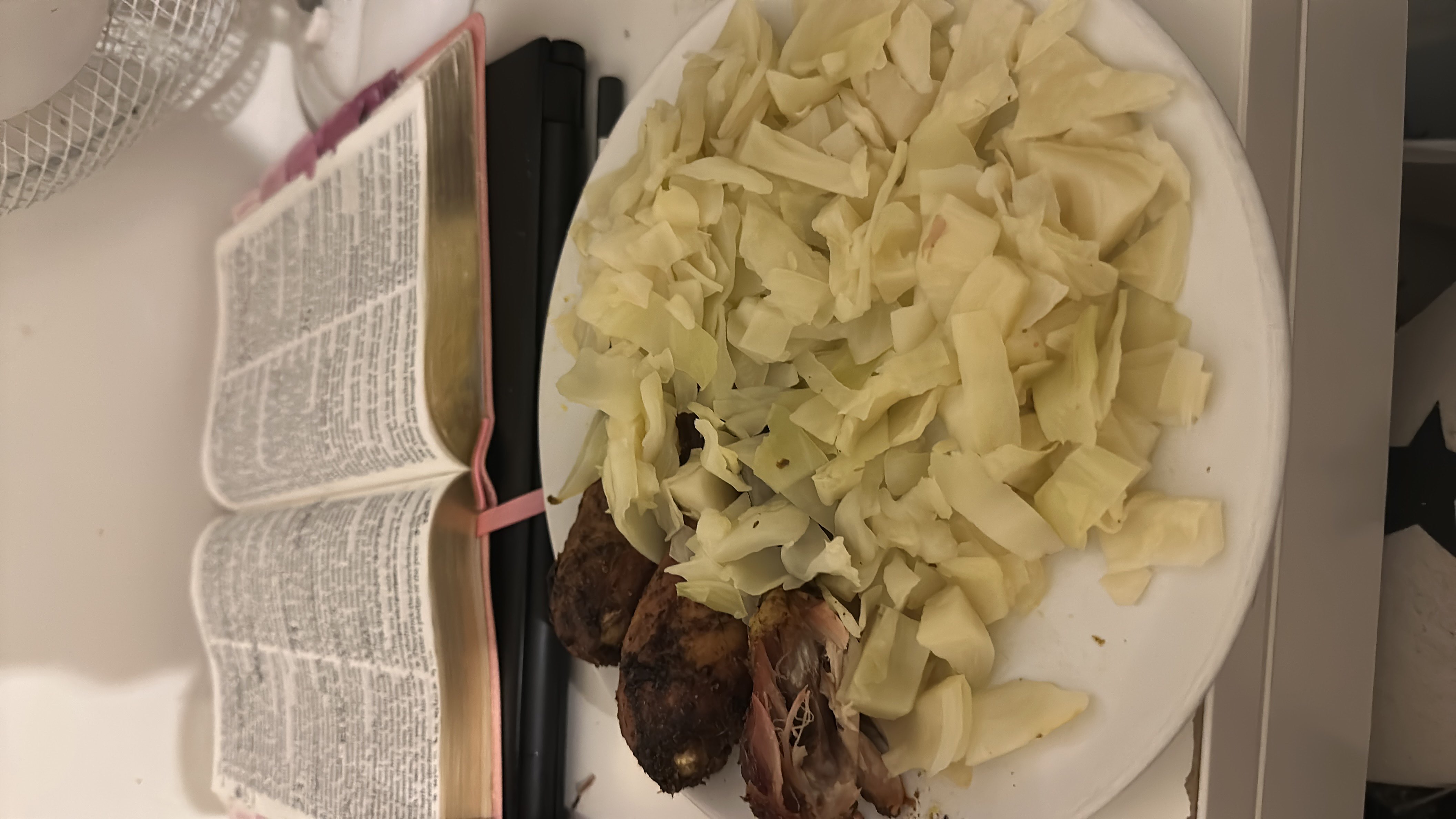 A plate containing cooked cabbage and seasoned chicken, providing a balanced meal with moderate calories and a high protein content.