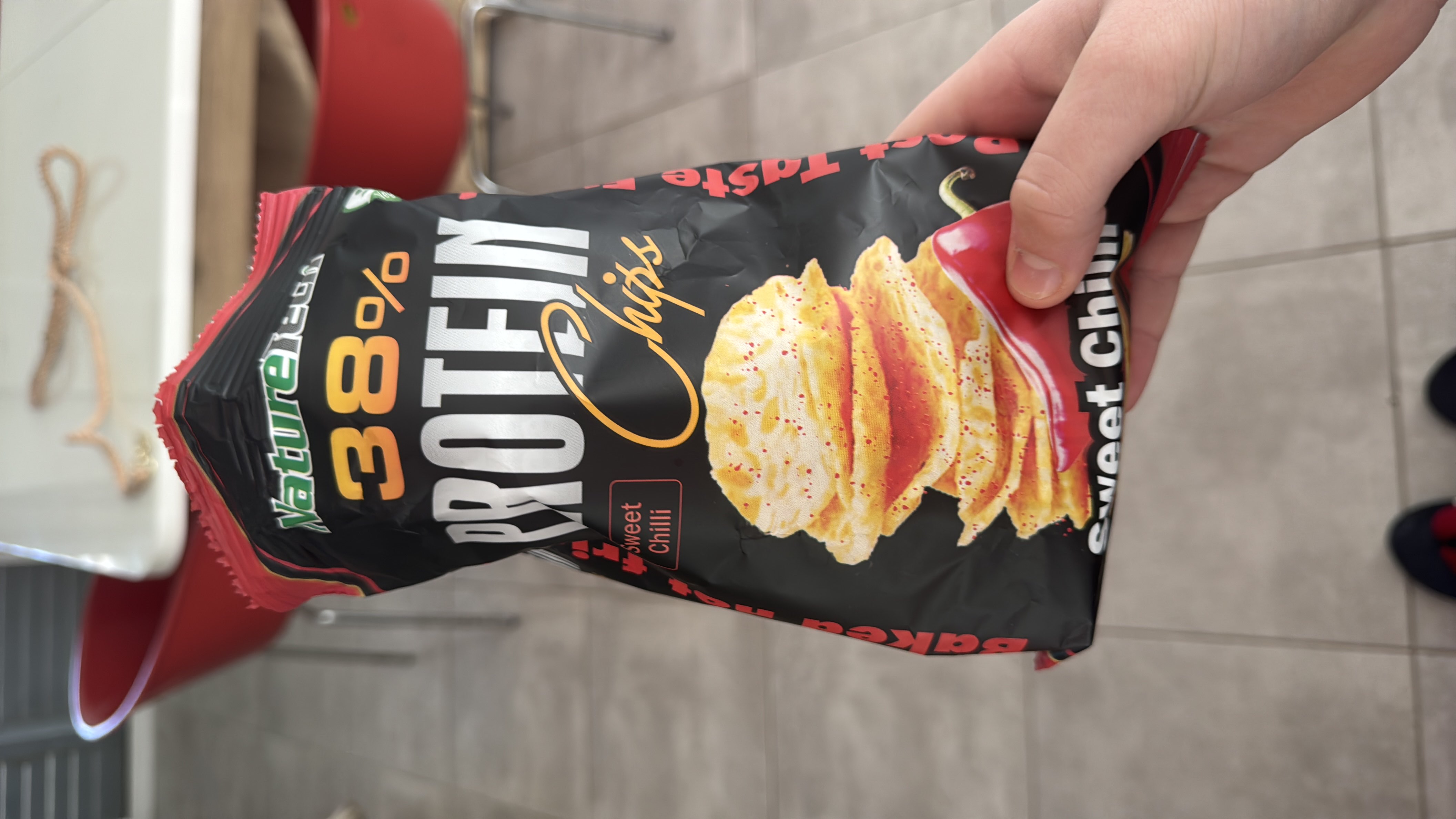 A high-protein snack with 38% protein content, featuring sweet chili flavor and baked chips.