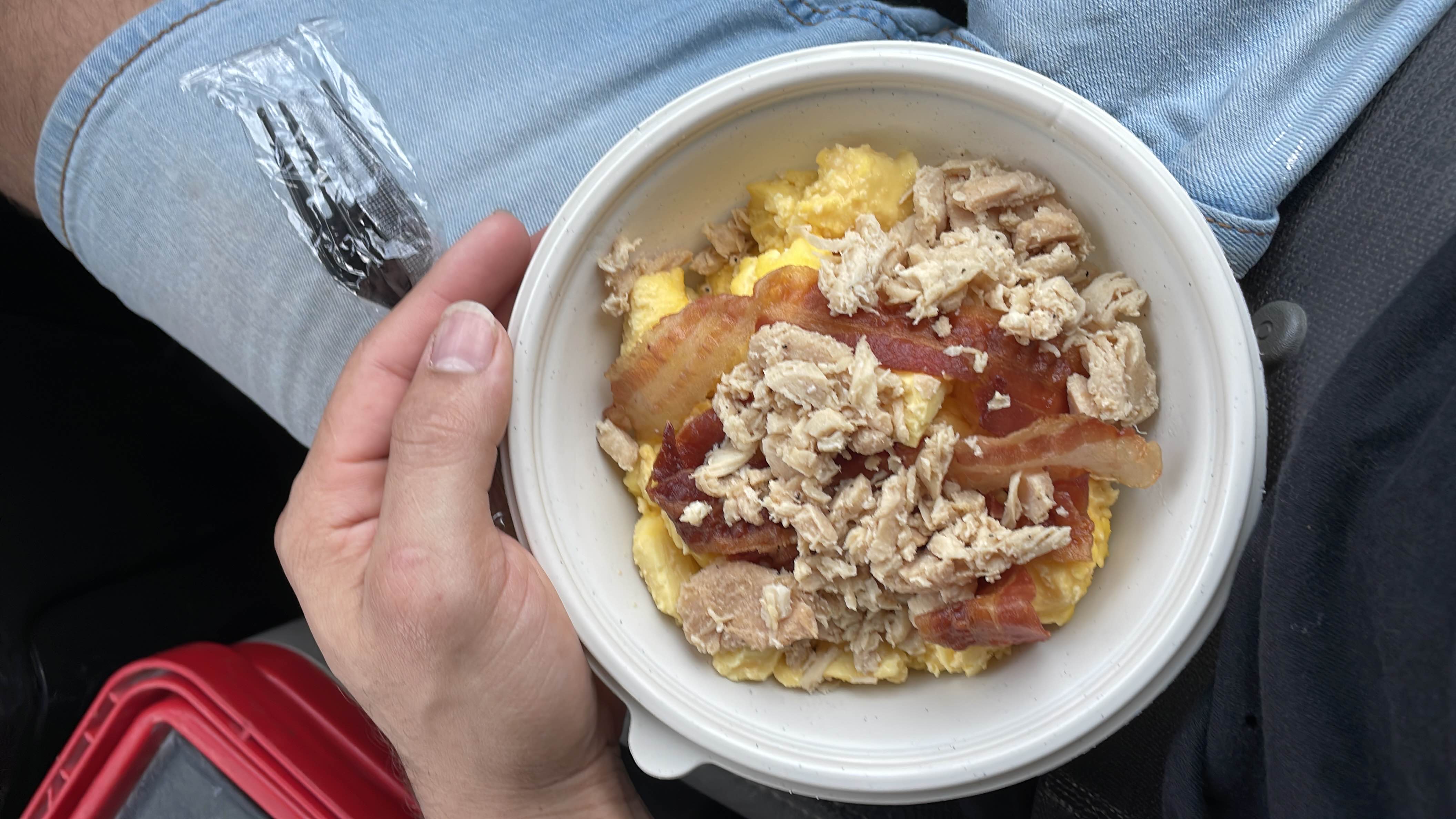 A high-protein meal consisting of scrambled eggs, bacon, and shredded chicken, suitable for a low-carb diet.