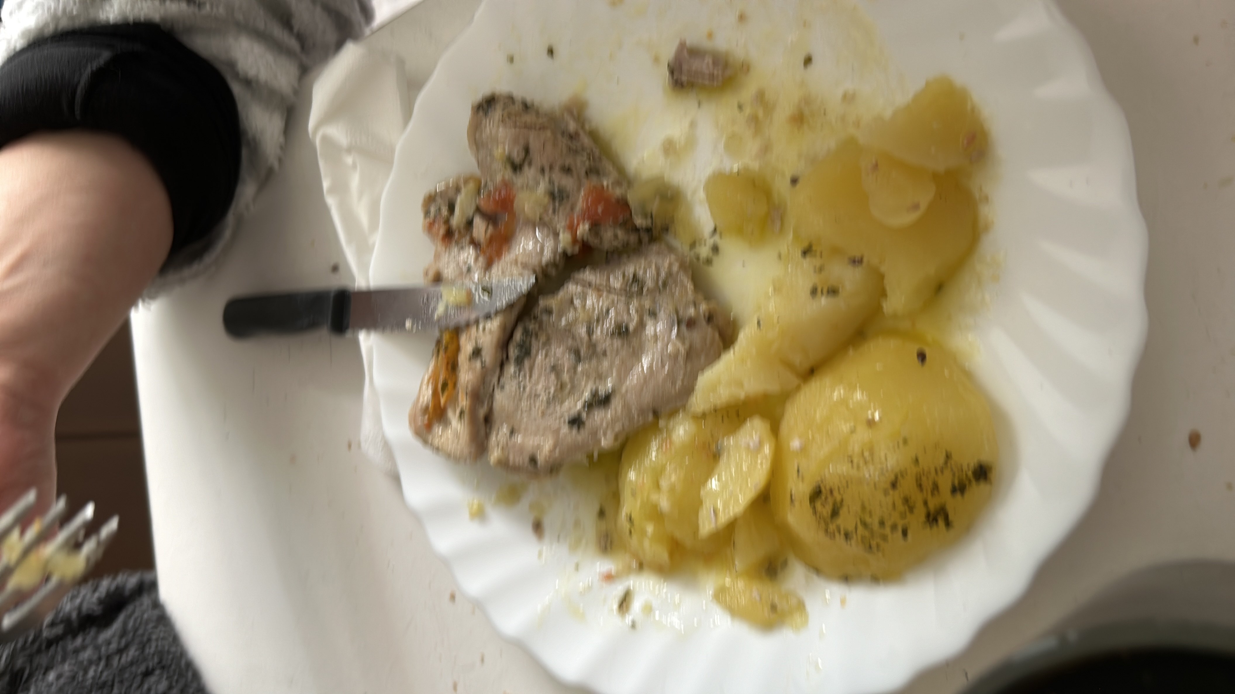 A plate containing cooked fish and seasoned potatoes, providing a balanced mix of protein, carbs, and fats.