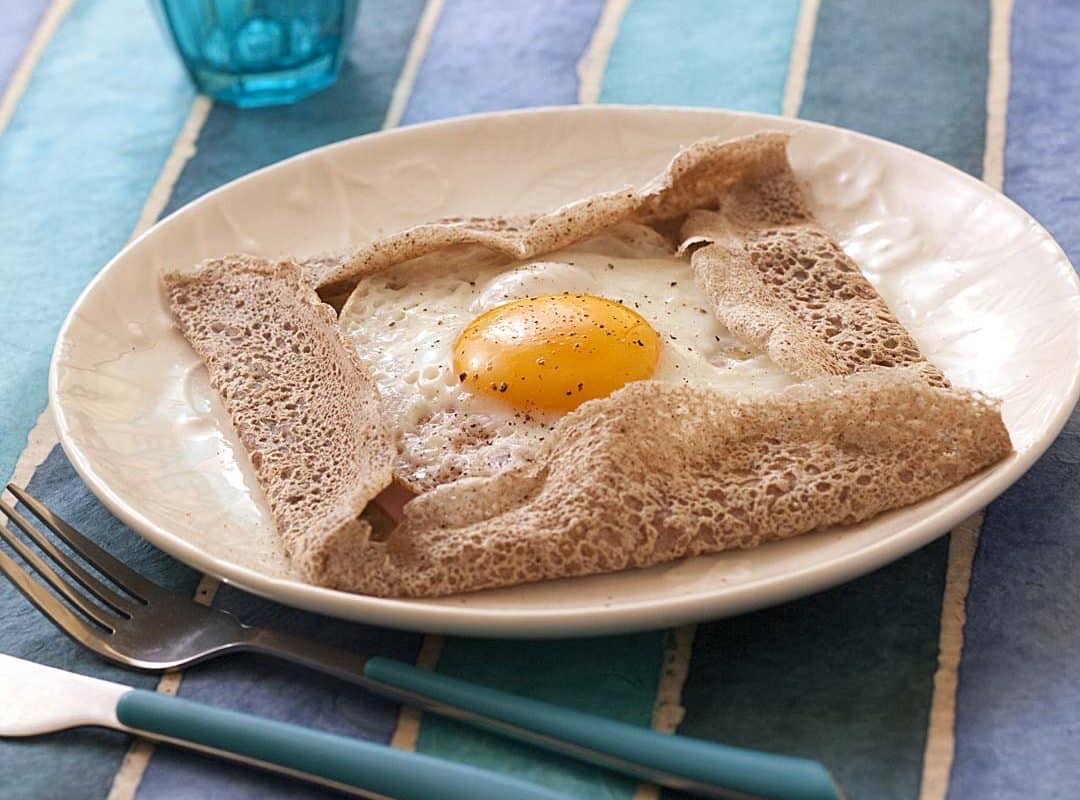 A buckwheat crepe with a sunny-side-up egg, providing a balanced mix of protein, carbs, and fats.