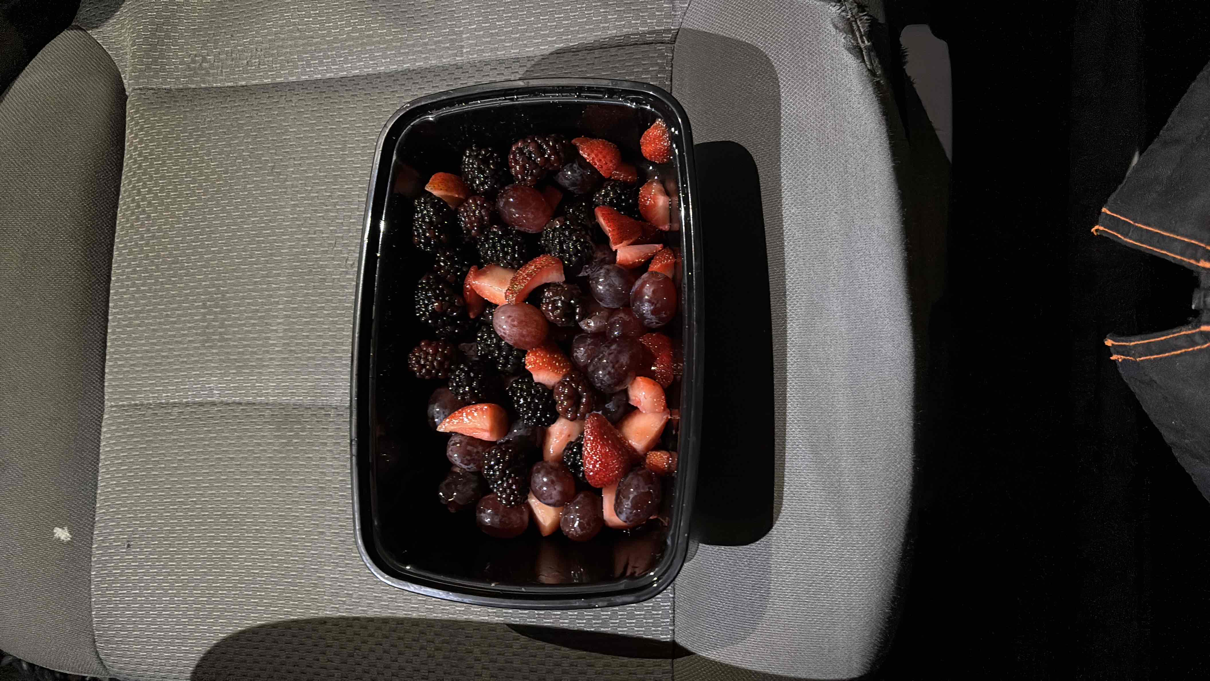 A fresh fruit mix containing strawberries, blackberries, and grapes, providing a healthy and nutrient-rich snack.