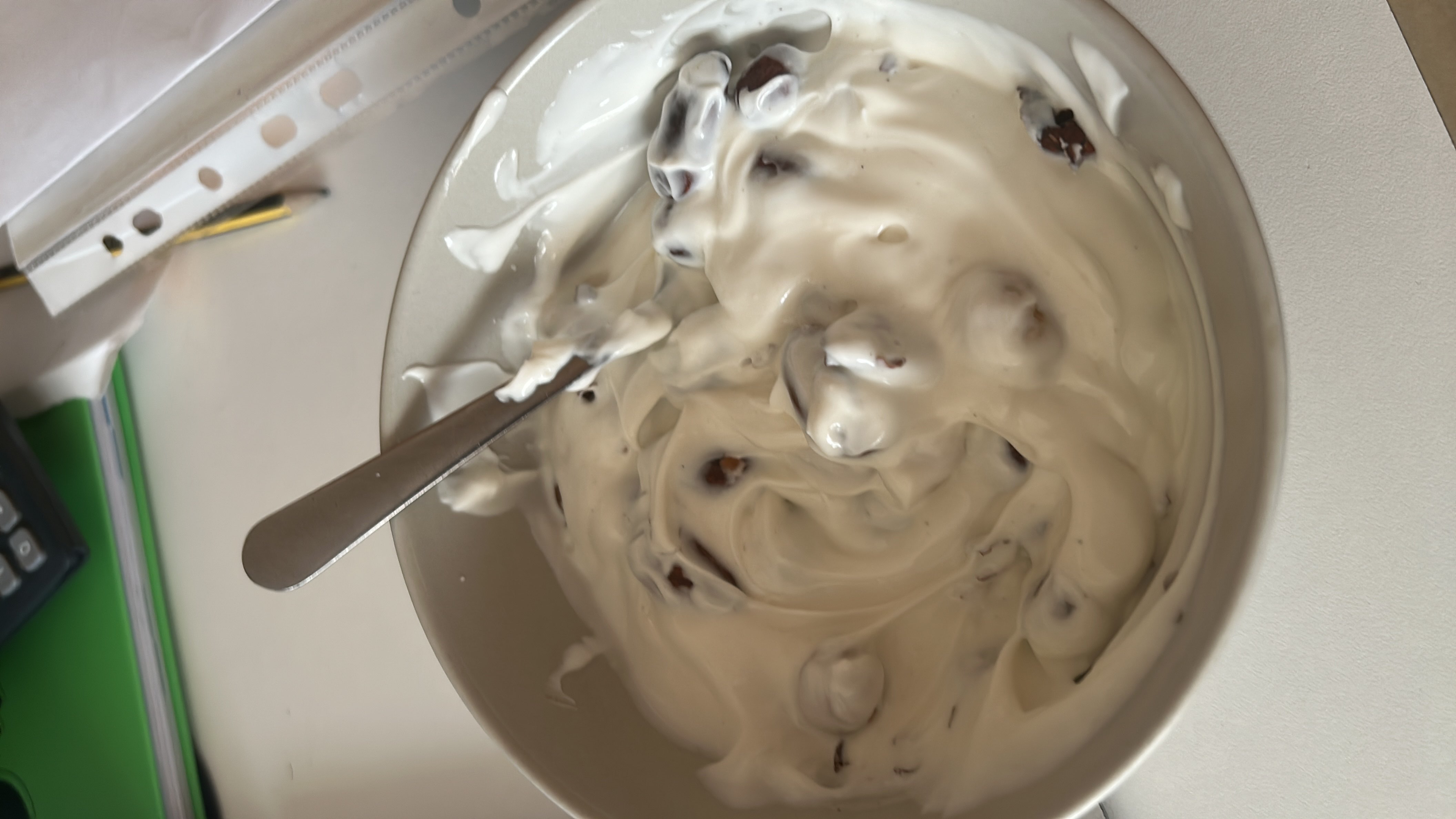 A bowl of creamy yogurt mixed with almonds and hazelnuts, providing a balance of protein, carbs, and fats.