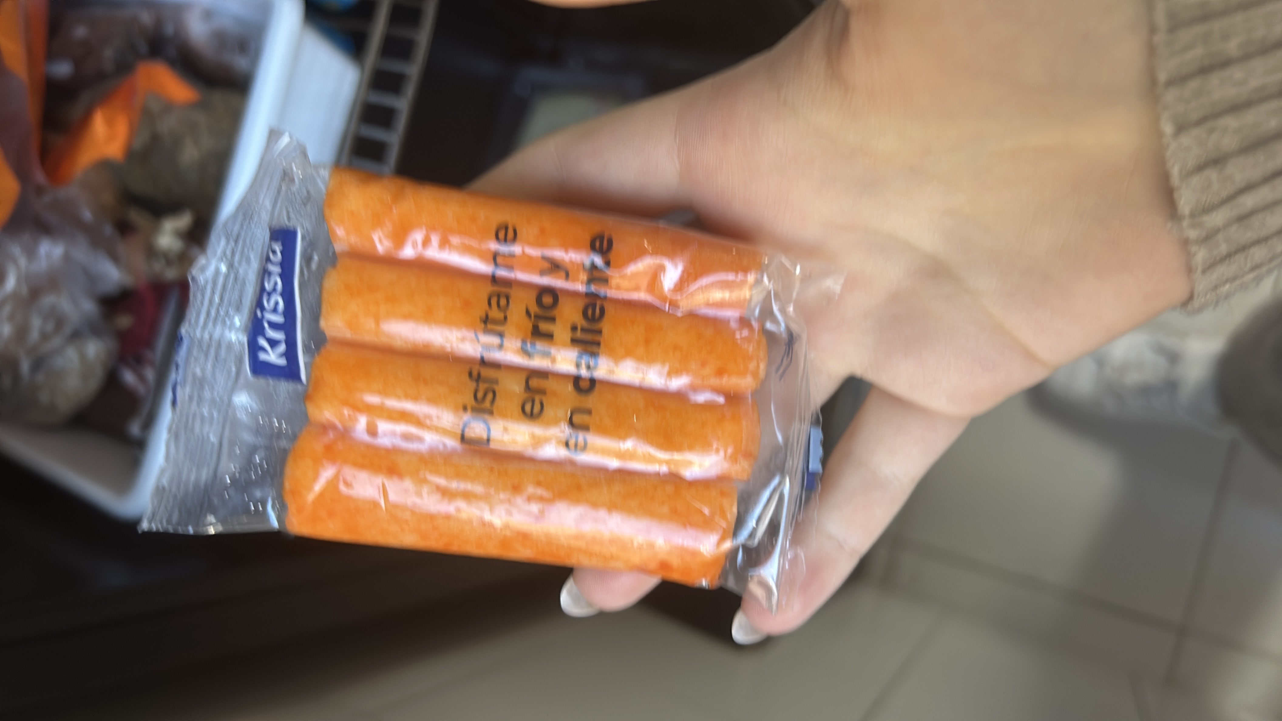 The image shows a package of surimi sticks, a low-calorie seafood product high in protein and low in fats and carbs.