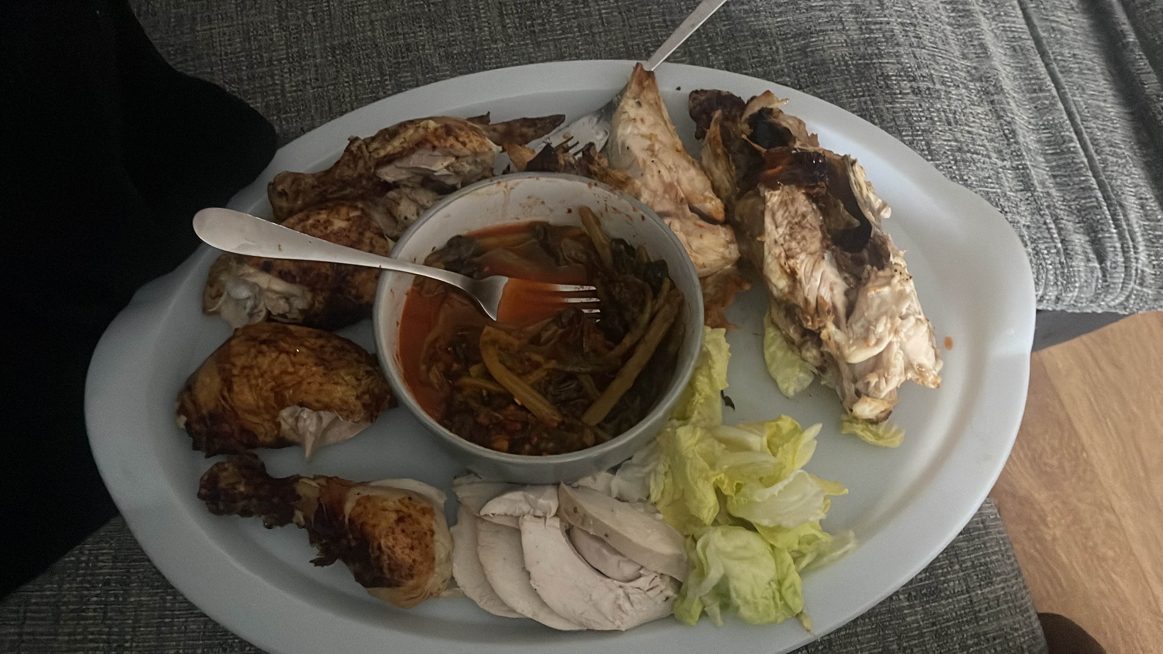 A high-protein meal featuring chicken thighs, steamed vegetables in tomato-based sauce, fresh lettuce, an apple, 3 slices of Sourdough rye bread with peanut butter and butter, and 2 lattes, offering increased carbohydrates and a slightly adjusted health score.