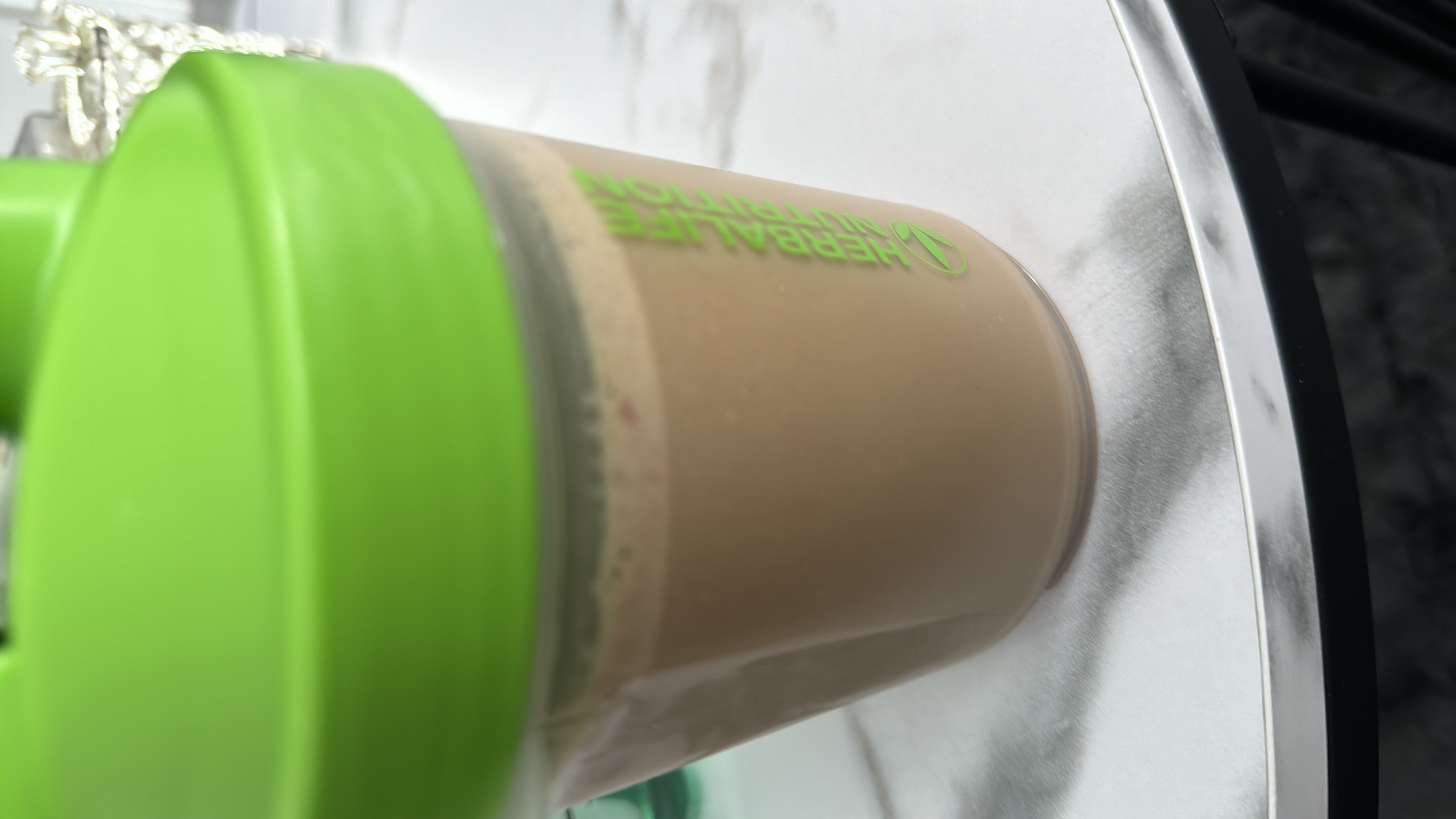 A protein shake made with a blend of protein powder, milk, and cocoa powder, providing a balanced nutritional profile.