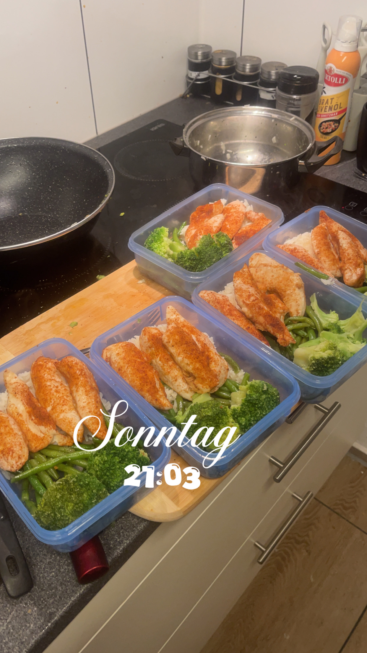 Meal prep containers with chicken breast, broccoli, green beans, and rice, providing a balanced and nutritious meal.