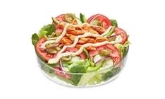 A fresh salad with lettuce, tomatoes, chicken, olives, and dressing.