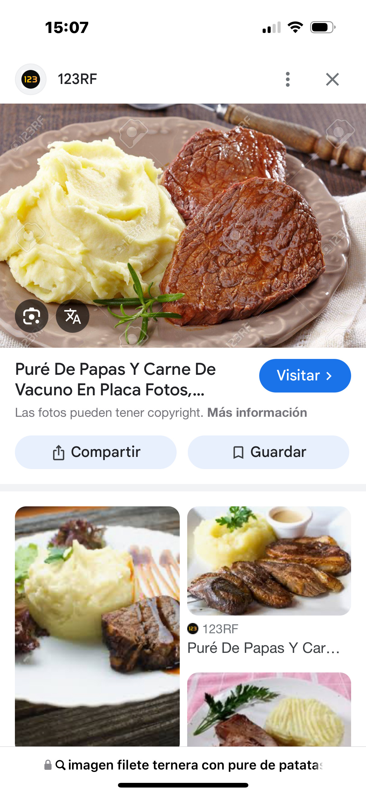 A dish consisting of creamy mashed potatoes and a grilled beef steak, garnished with a sprig of rosemary.