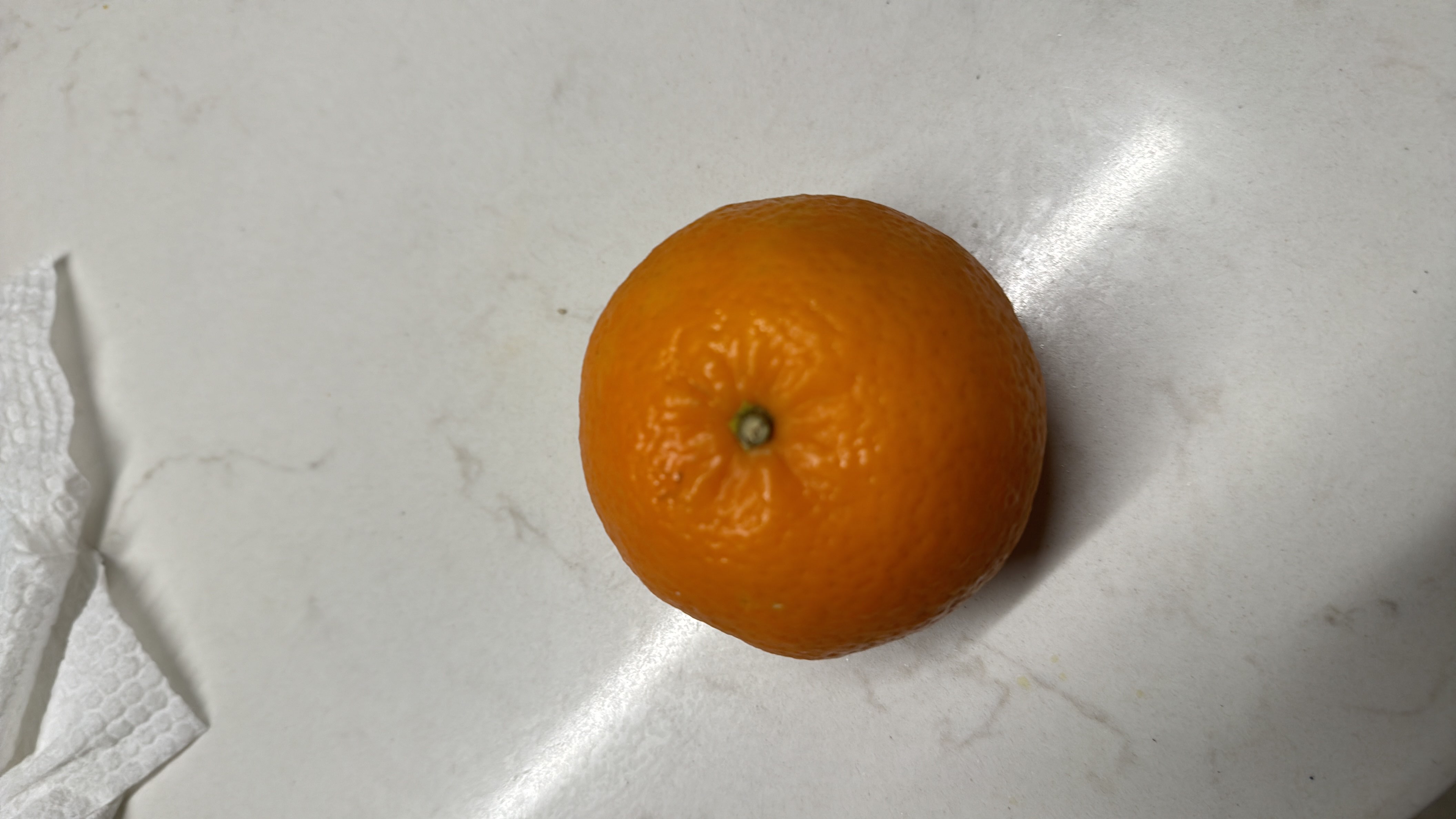 The image shows an orange, a citrus fruit that is low in calories and rich in vitamin C, making it a healthy snack option.