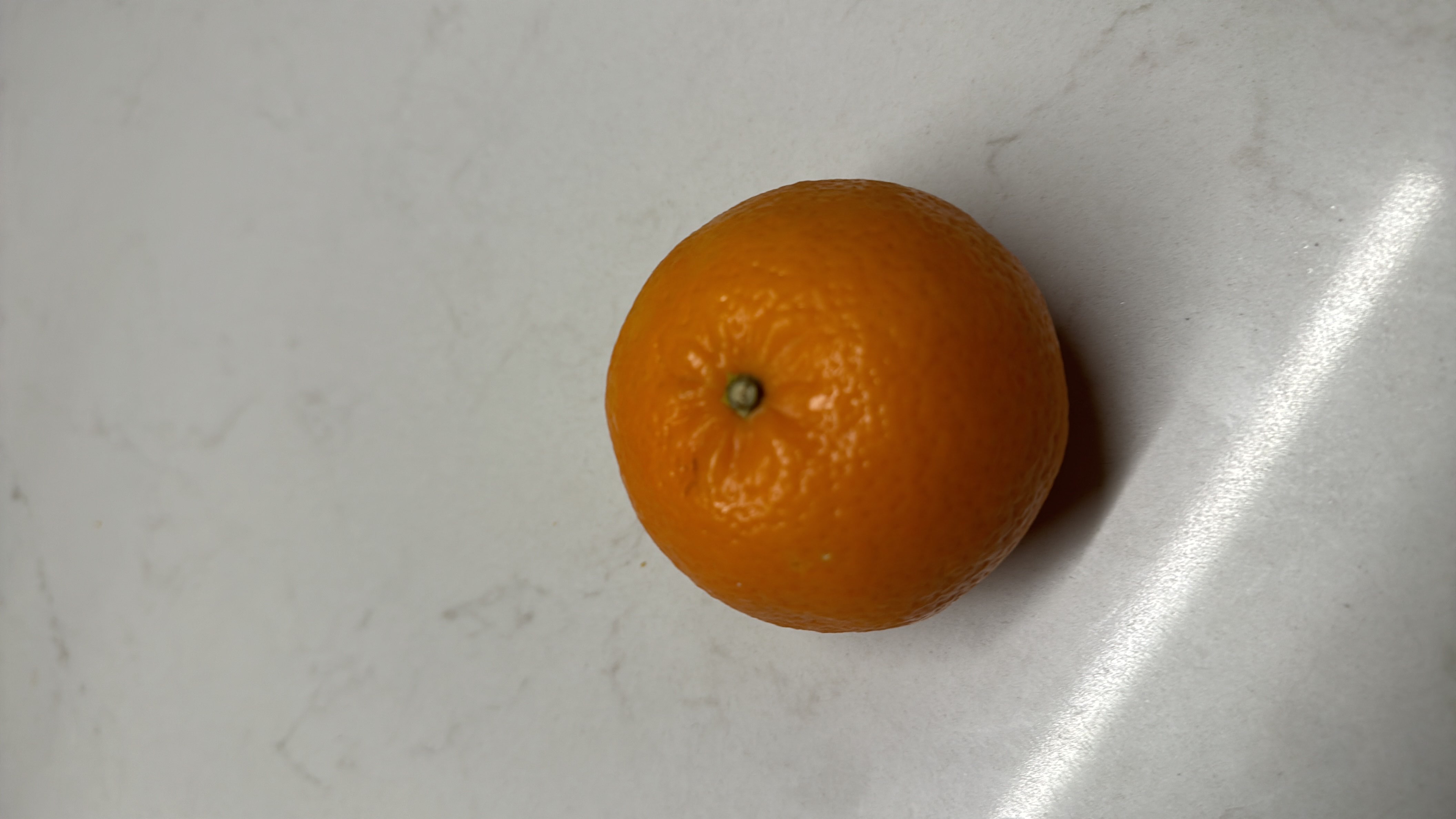 The image shows an orange, a low-calorie fruit rich in vitamin C and dietary fiber.