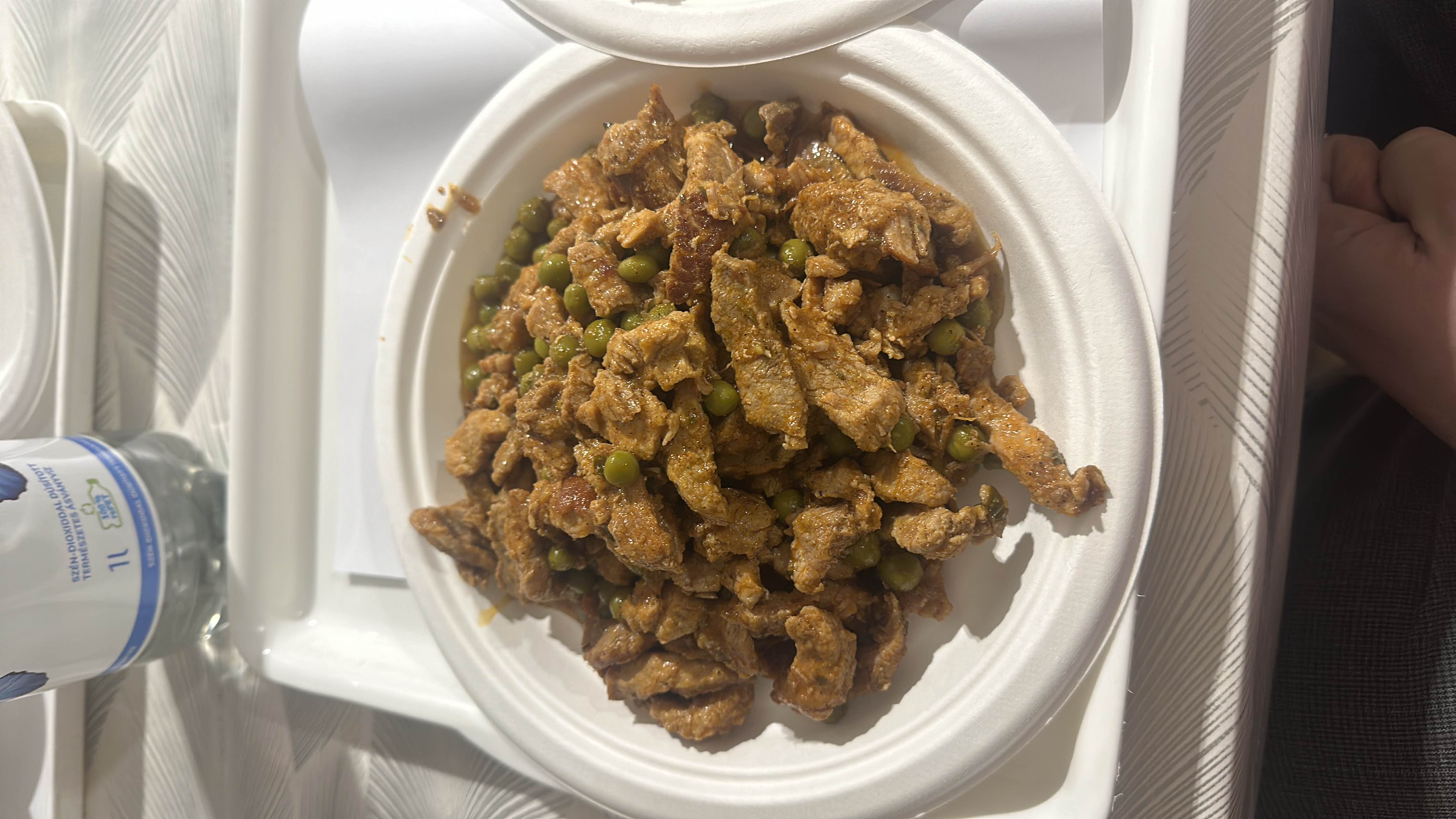 A dish consisting of seasoned beef strips and green peas, cooked with spices and oil, providing a balanced mix of protein, carbs, and fats.