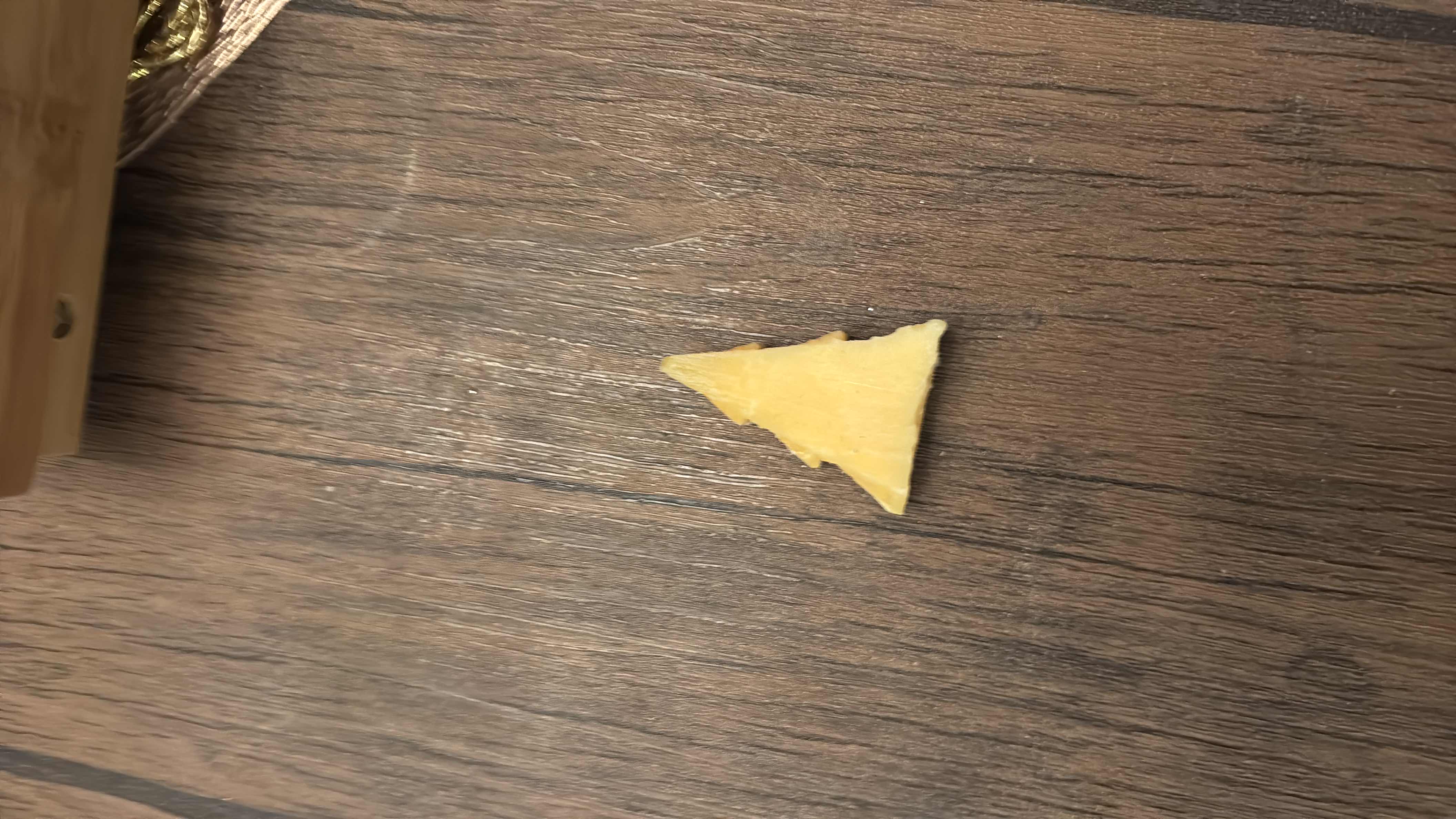 A small piece of cheese shaped like a Christmas tree, providing moderate calories and protein with minimal carbs.