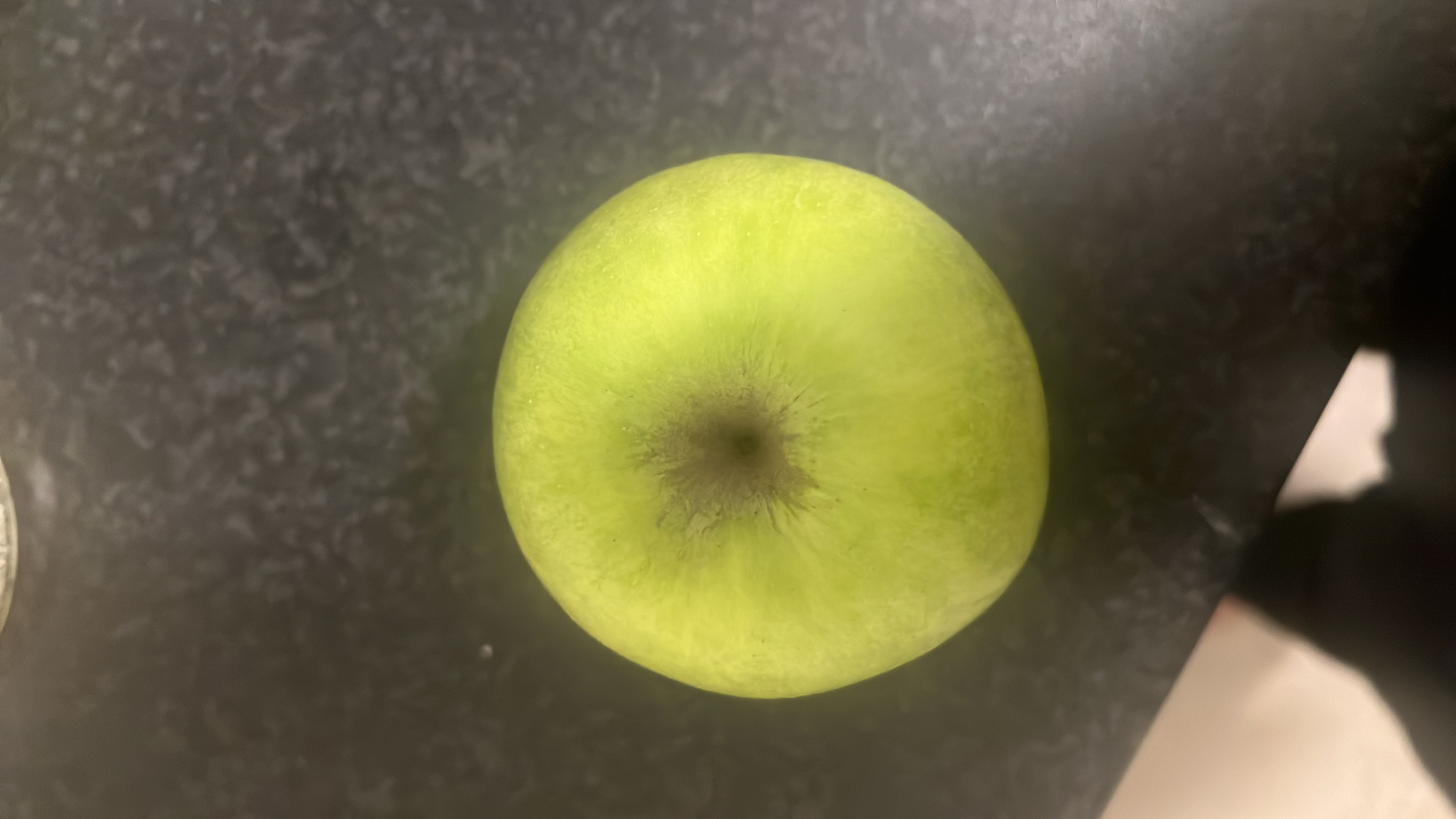 This is a green apple, a nutritious fruit that is low in calories and fats, and high in carbohydrates, primarily from natural sugars.