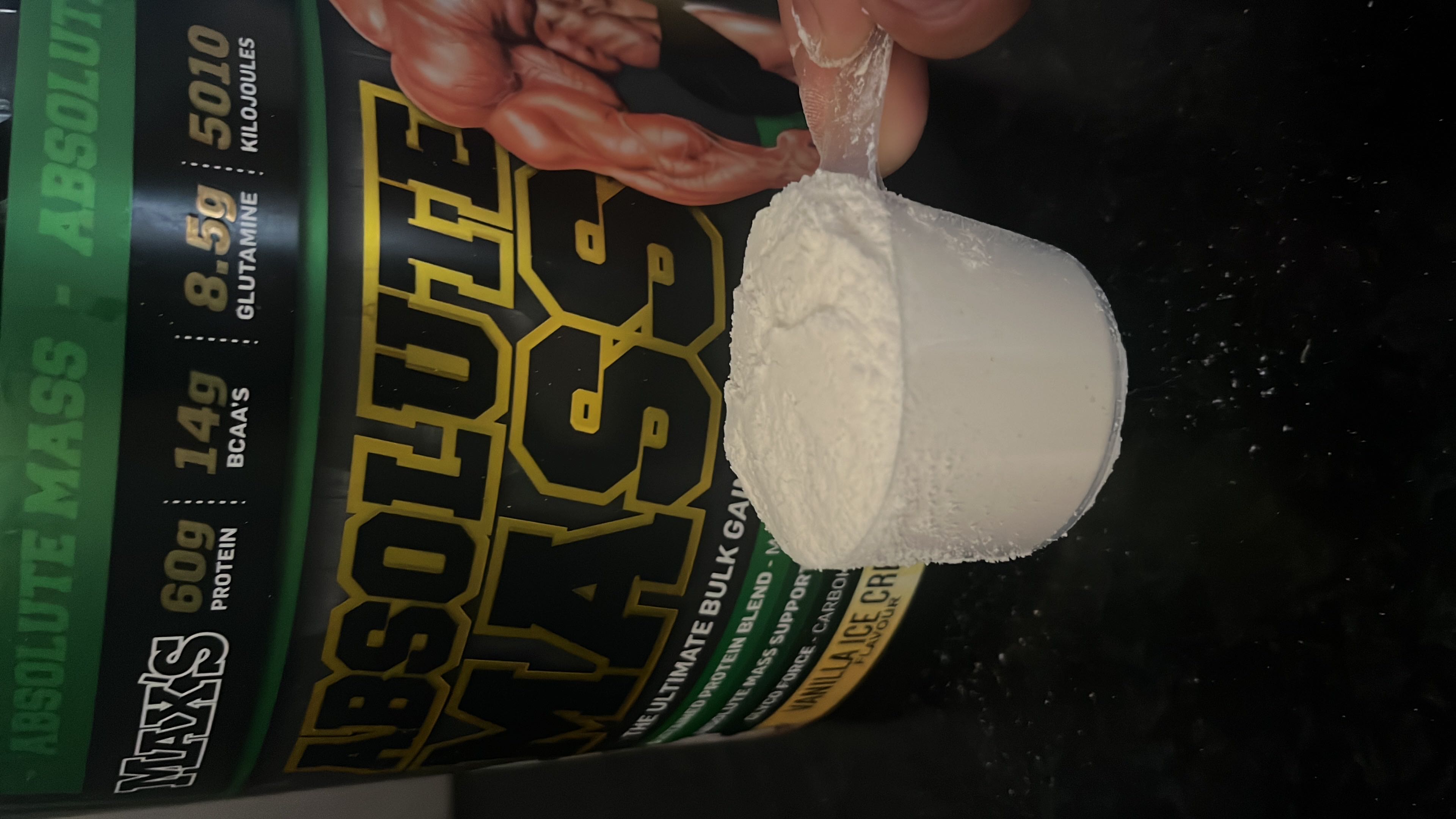 Max's Absolute Mass is a high-calorie protein powder designed for muscle gain, featuring 60g of protein, 150g of carbs, and 10g of fats per serving.