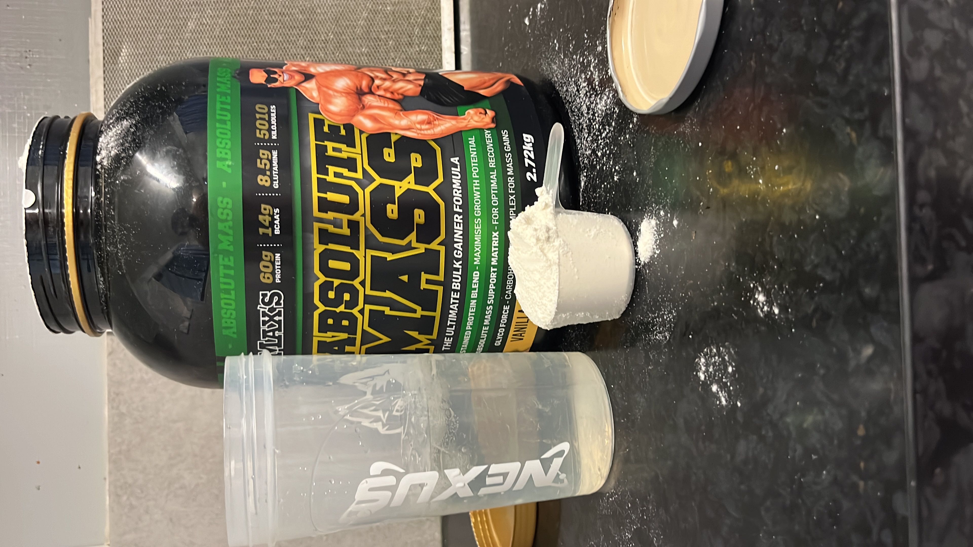 A high-calorie mass gainer supplement with 60g protein, 200g carbs, and 10g fats per serving, designed for muscle growth and recovery.