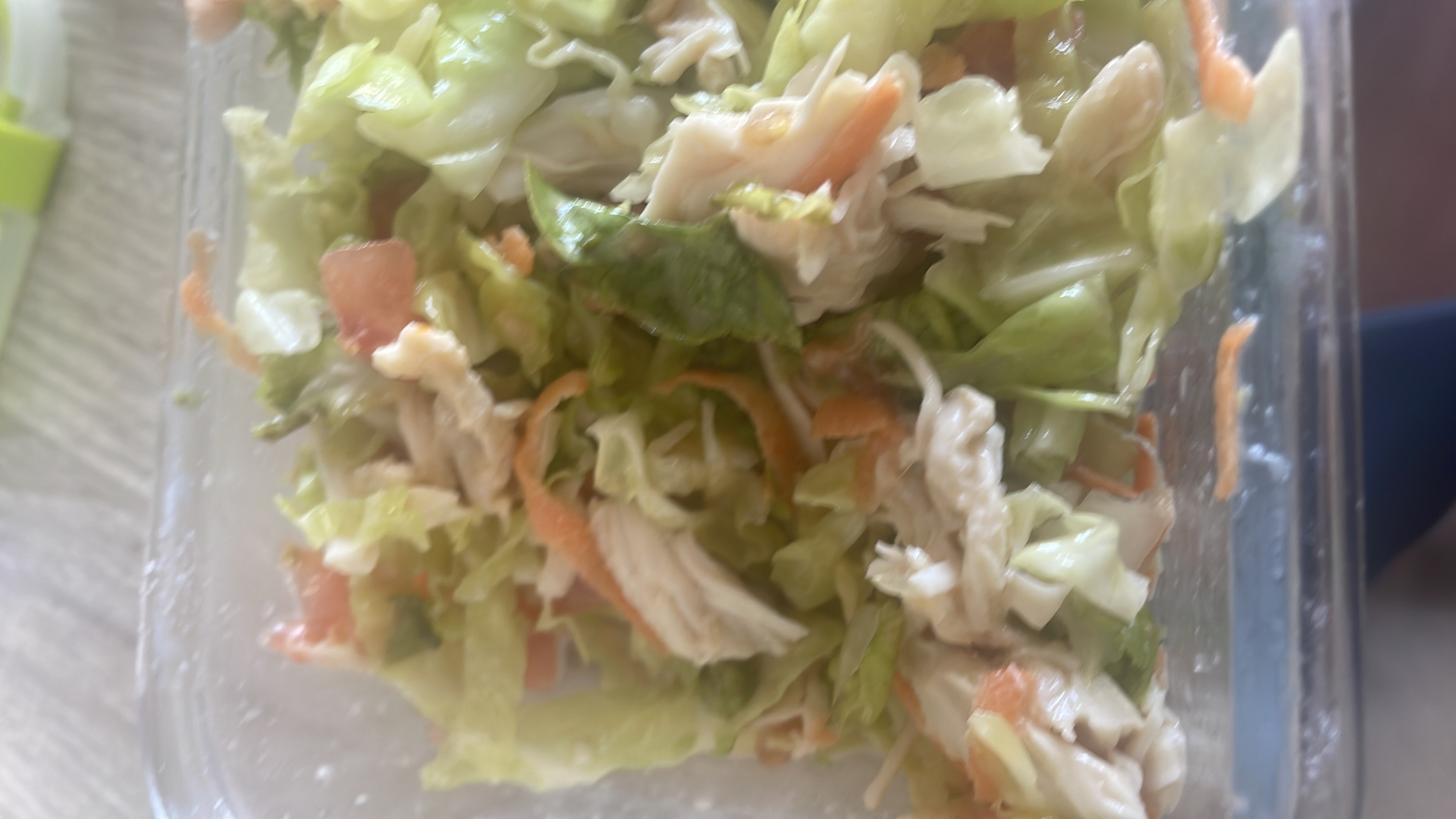 A healthy salad containing lettuce, carrots, chicken, and tomatoes, providing a balanced mix of protein, carbs, and fats.