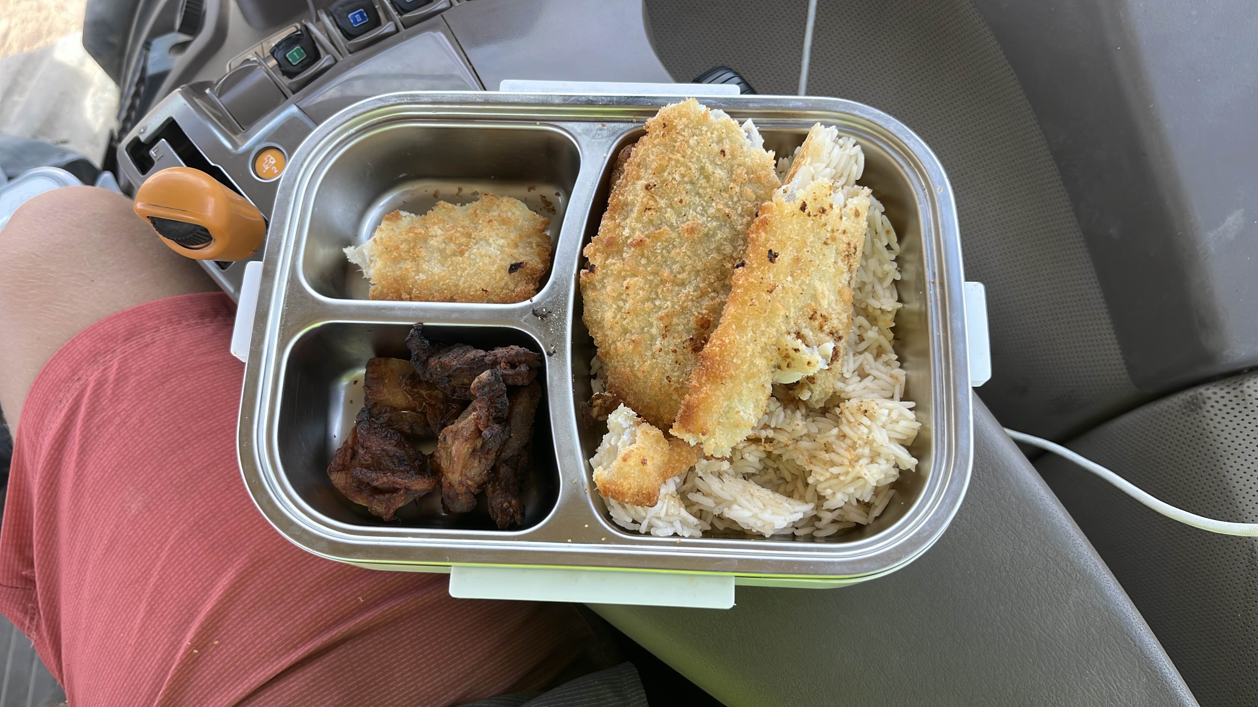 A meal consisting of rice, fried fish, and grilled meat, providing a balanced mix of protein, carbs, and fats.