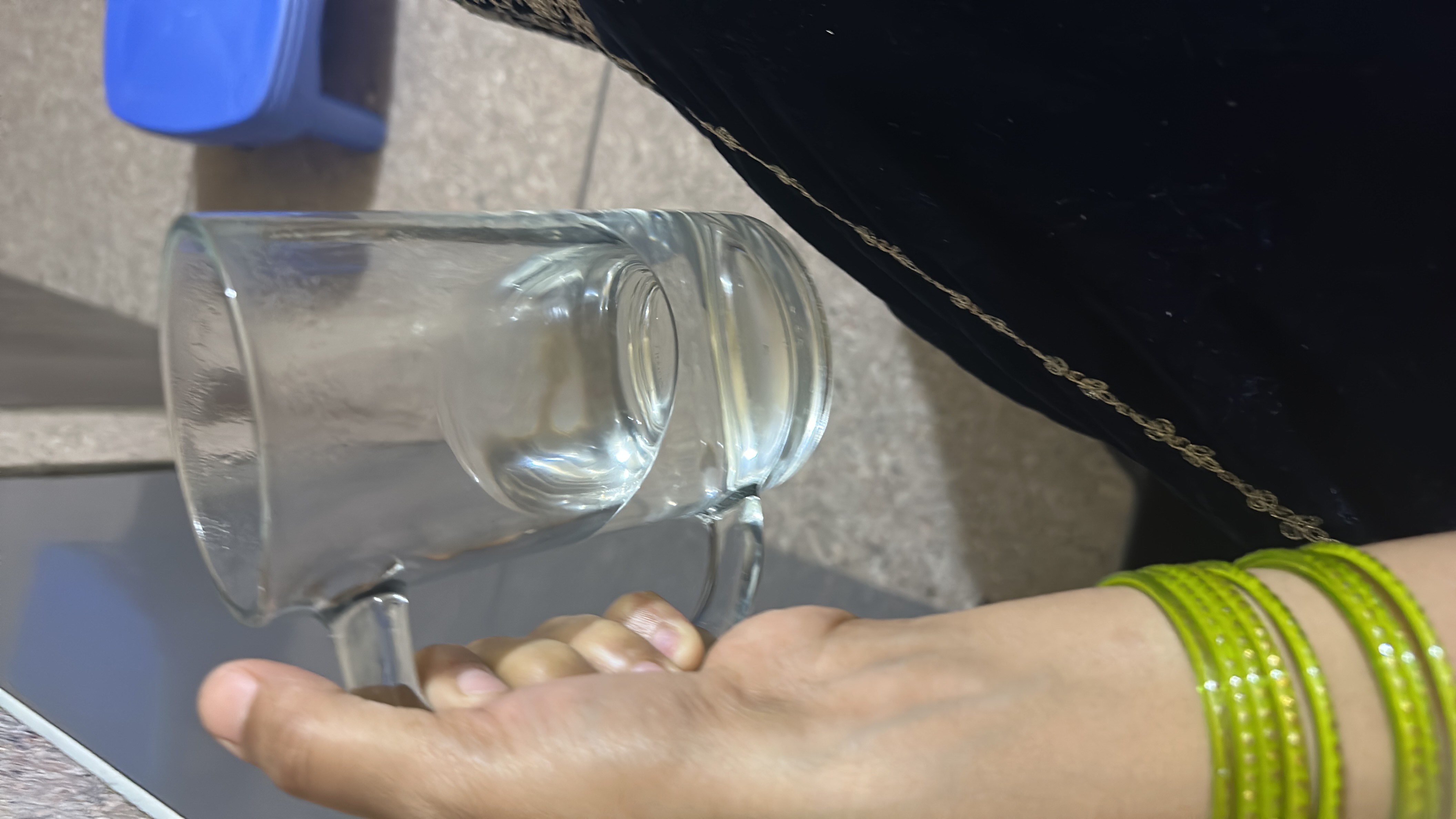 The image shows a glass of water, which contains no calories, protein, carbs, or fats, and is highly hydrating.