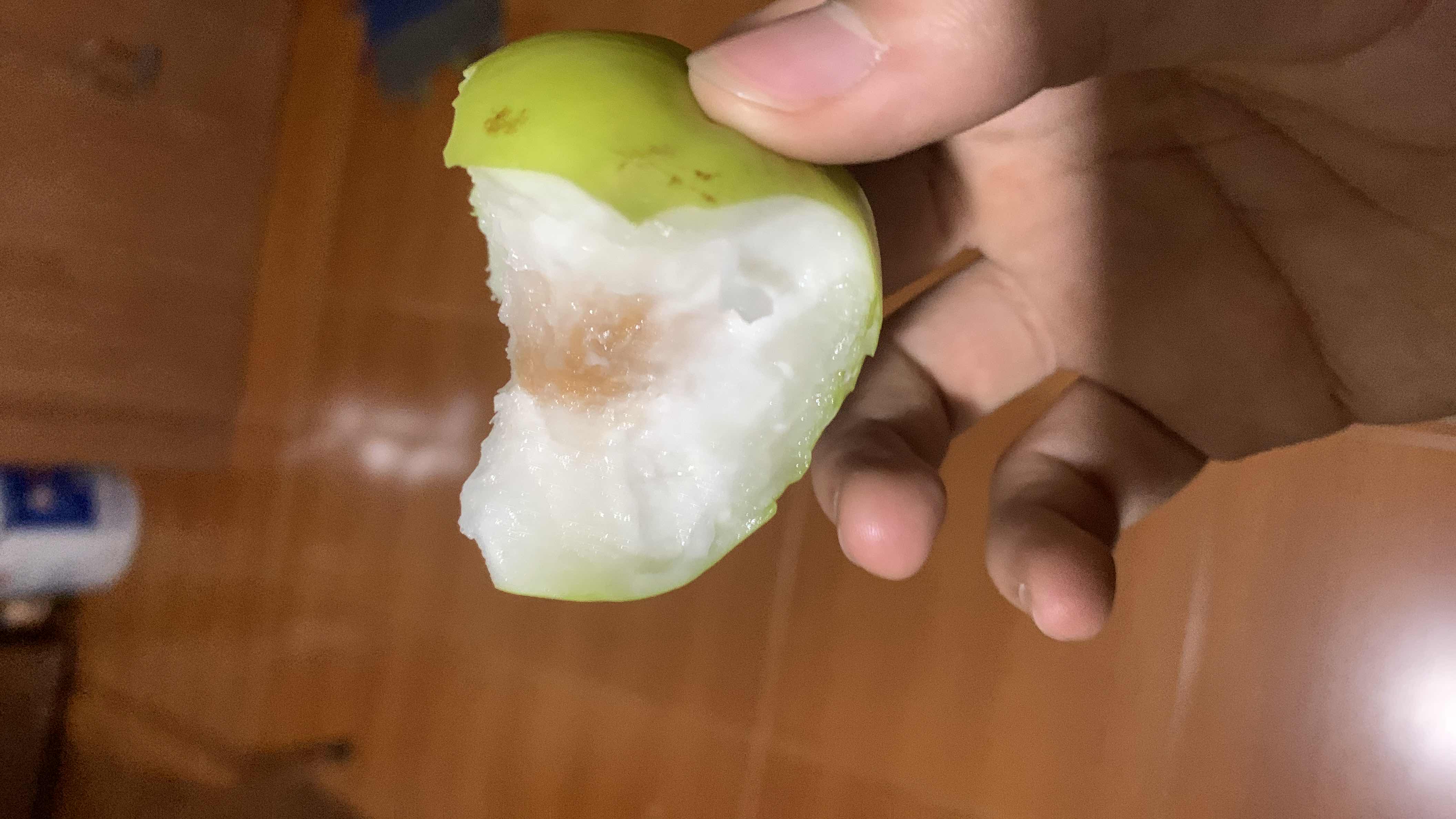 The image shows a partially eaten guava, a fruit that is low in calories and rich in vitamins and fiber.
