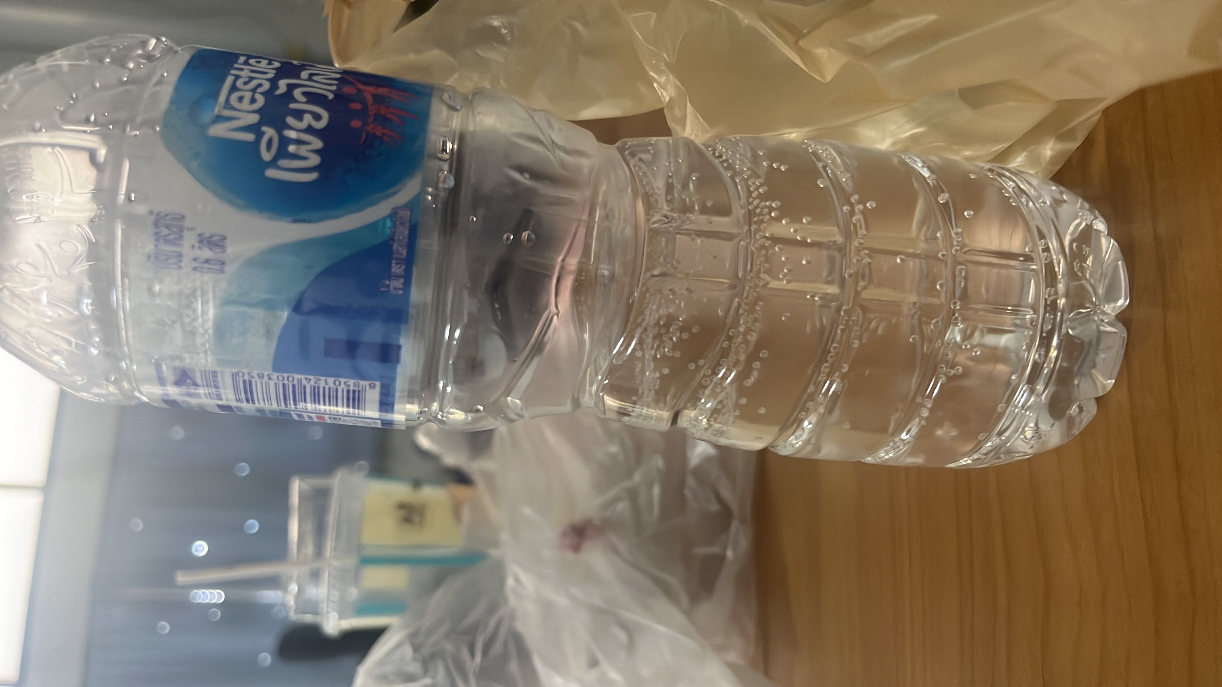 The image shows a bottle of Nestlé drinking water, which contains no calories, protein, carbs, or fats.