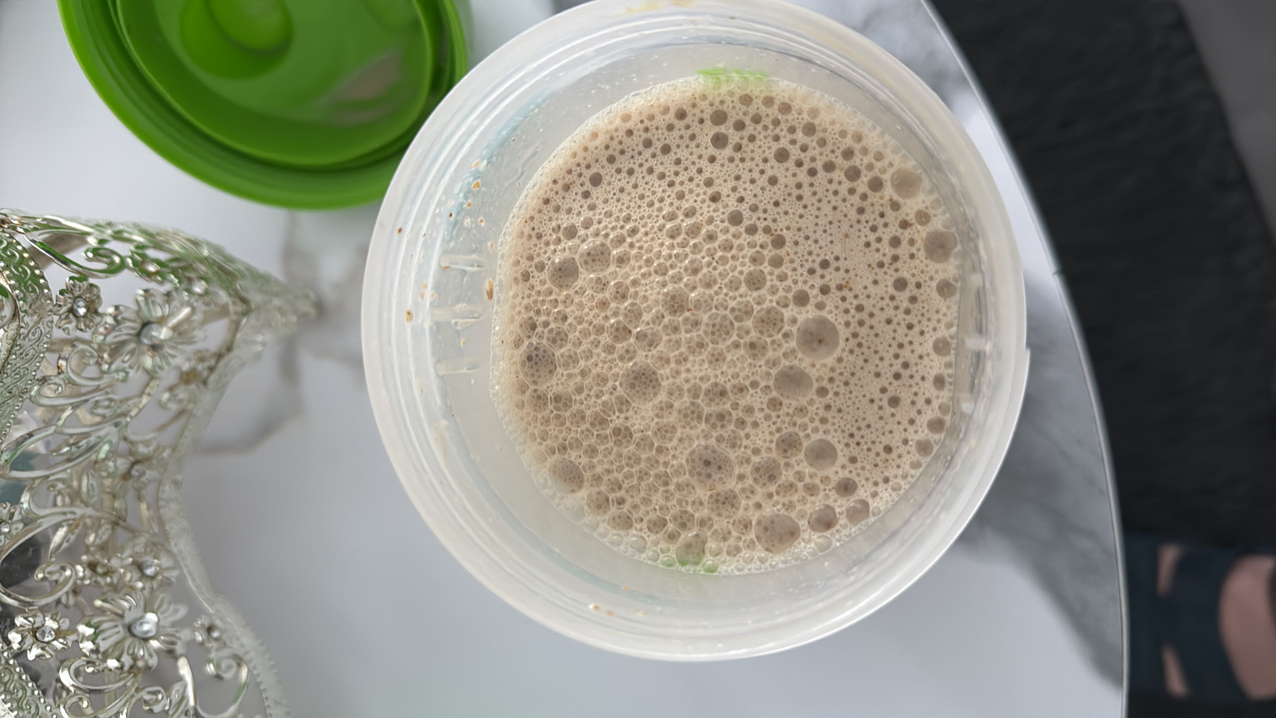 A protein shake made with protein powder, almond milk, and banana, providing a balanced mix of protein, carbs, and fats.