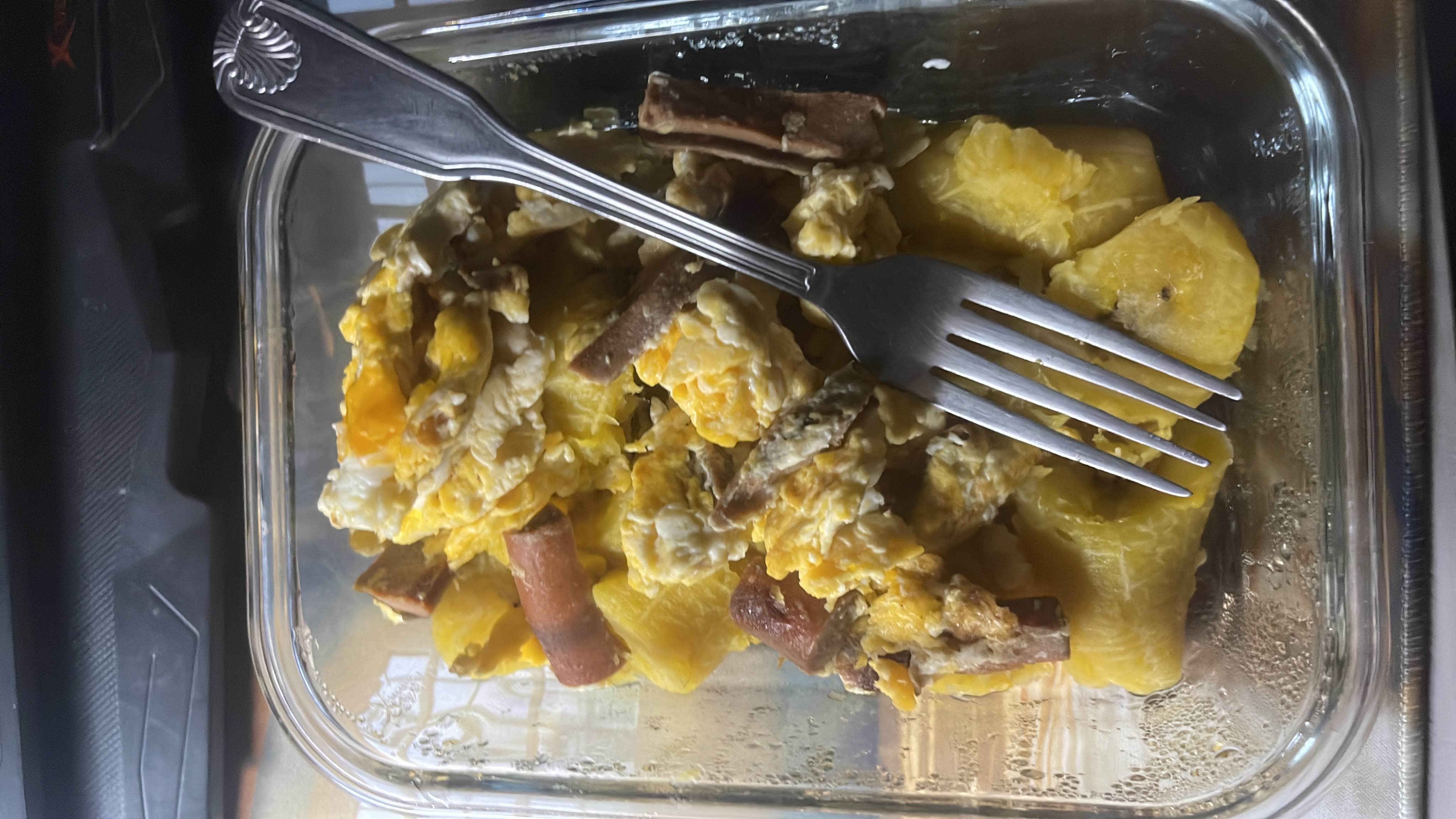 A dish consisting of scrambled eggs, cooked plantains, and sausage, providing a balanced mix of protein, carbs, and fats.